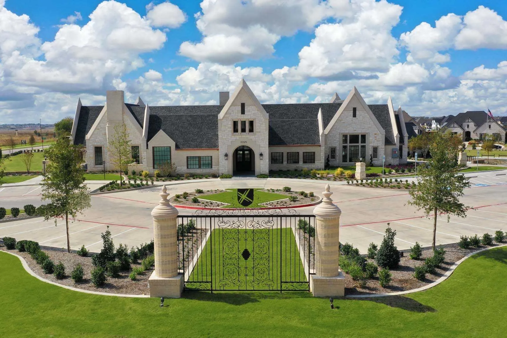 Stone façade with multiple gables, dark shingle roof, and a prominent front entrance