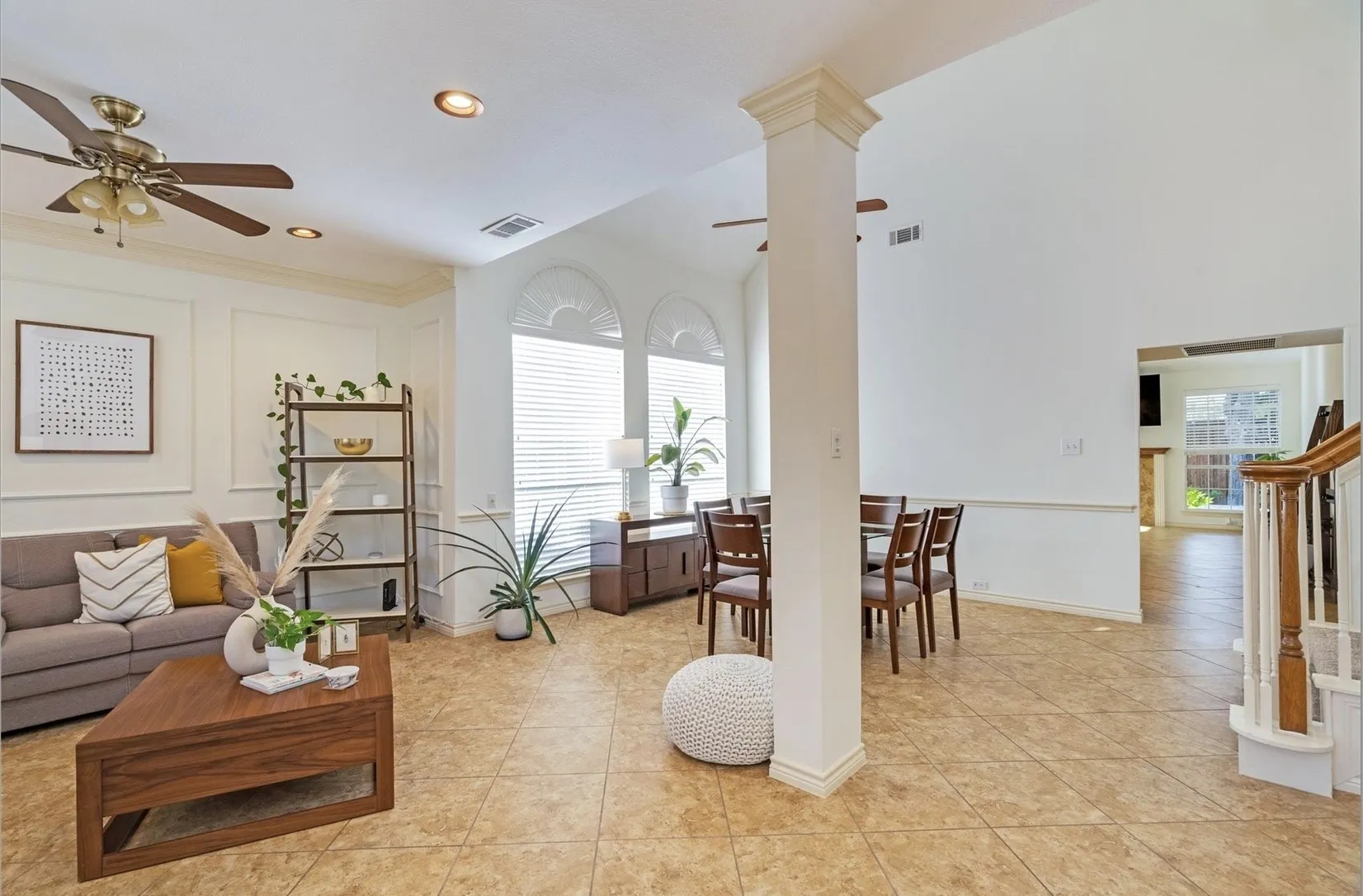 Expansive living area featuring tile flooring, a high ceiling, and recessed lighting