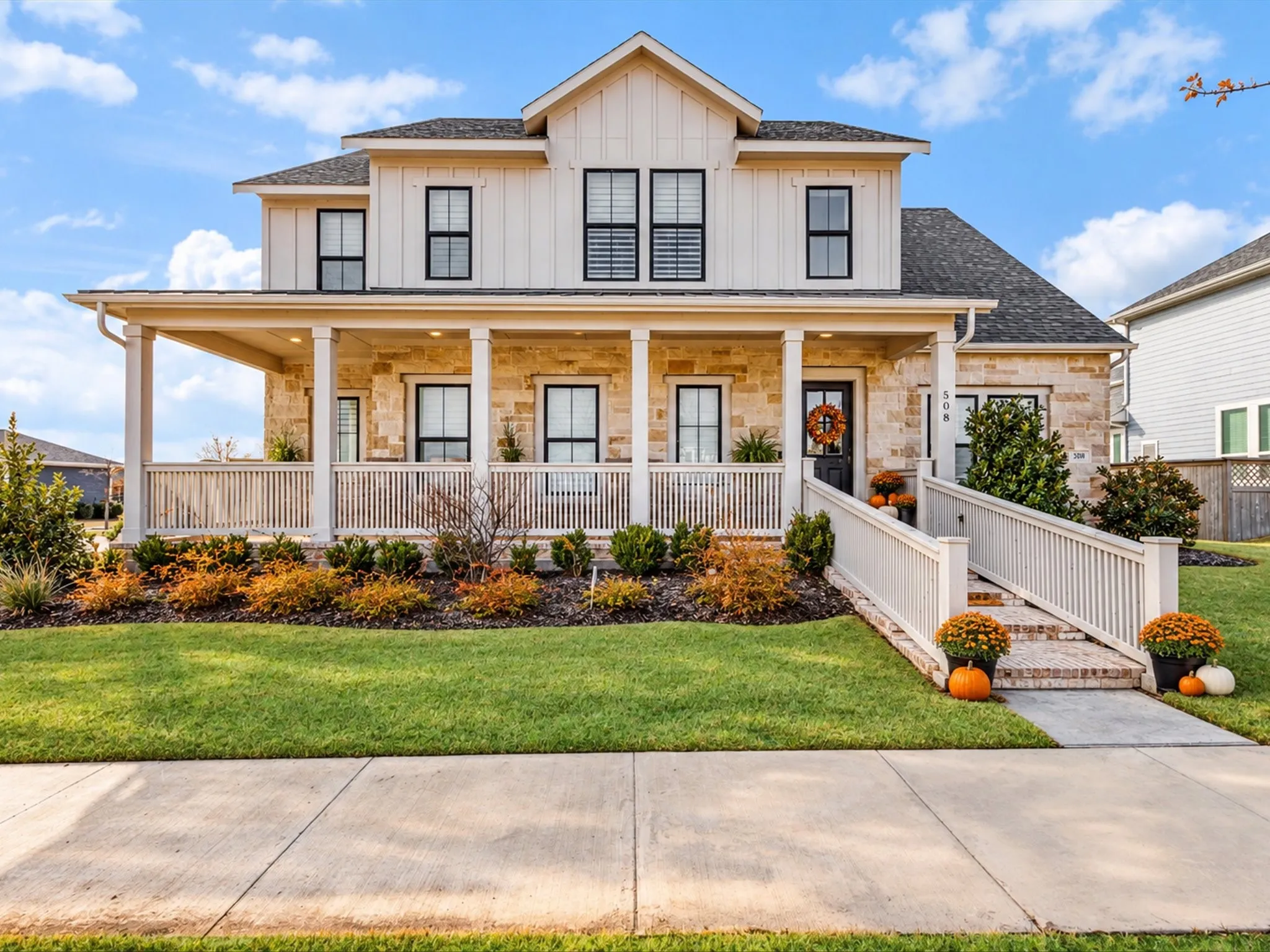 Stone and board-and-batten exterior with an expansive covered porch