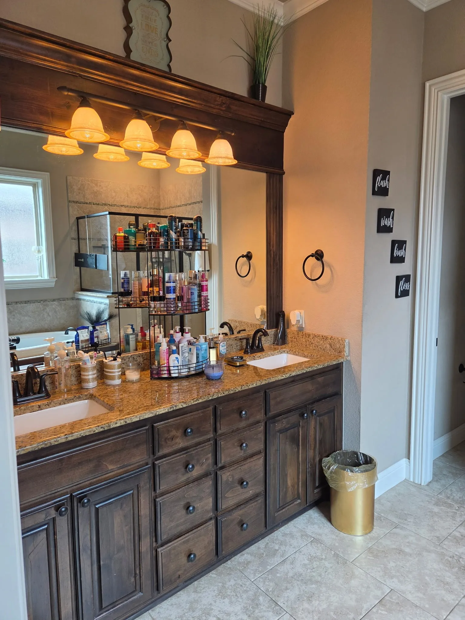 Dual vanity with dark wood cabinetry and granite countertops