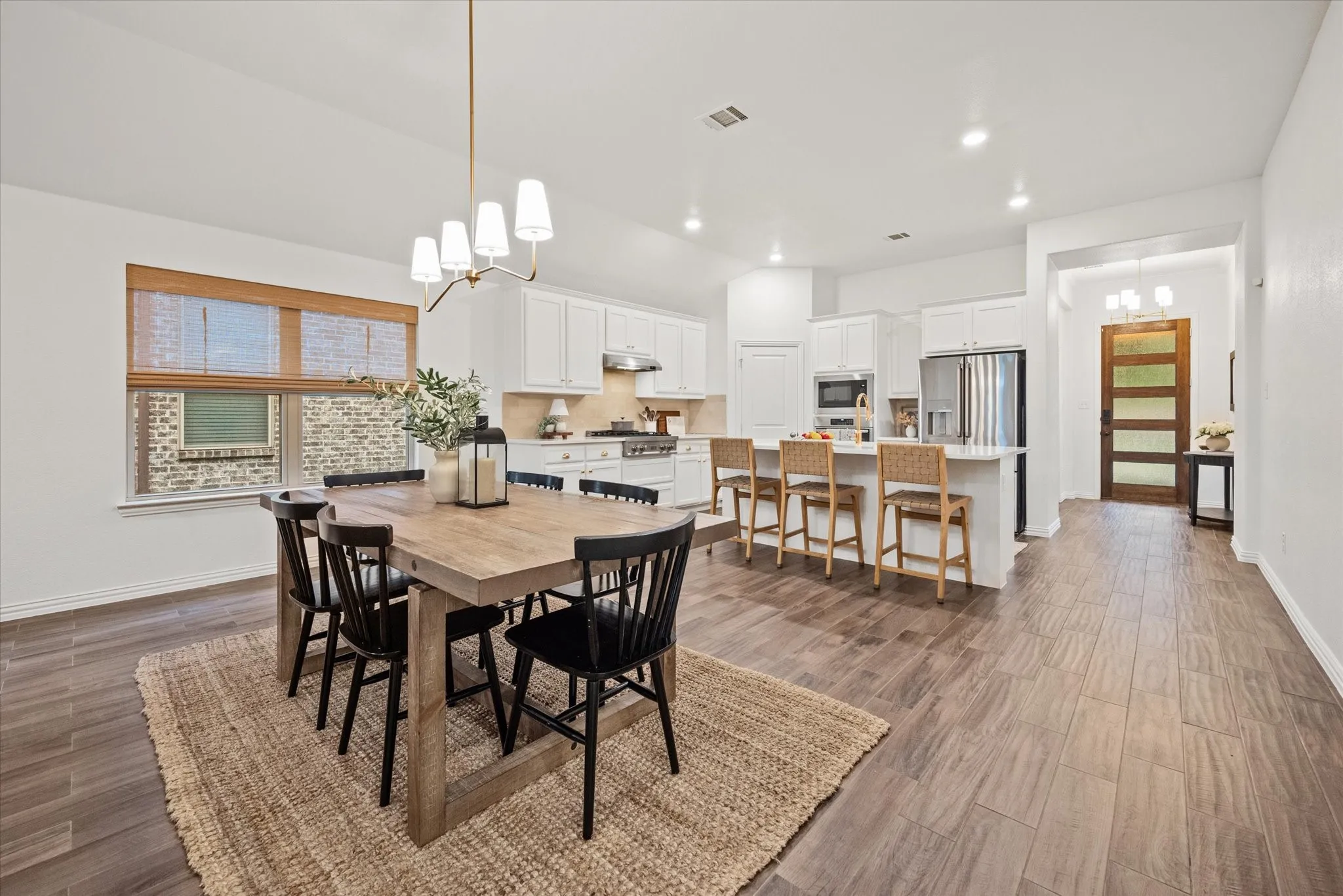 Recessed lighting illuminates the space, featuring wood-finish flooring throughout