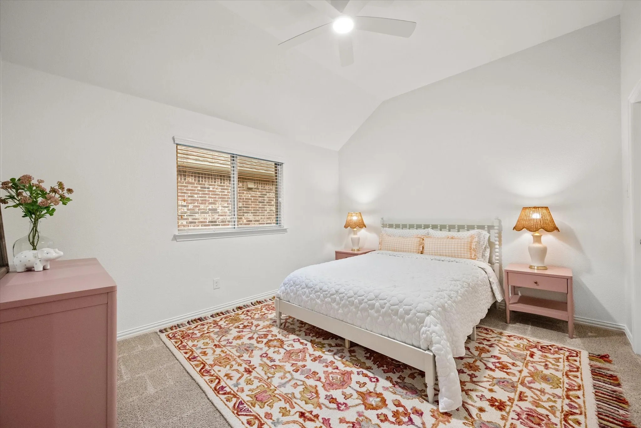 Vaulted ceiling, ceiling fan, neutral wall paint, window with blinds, carpeted flooring