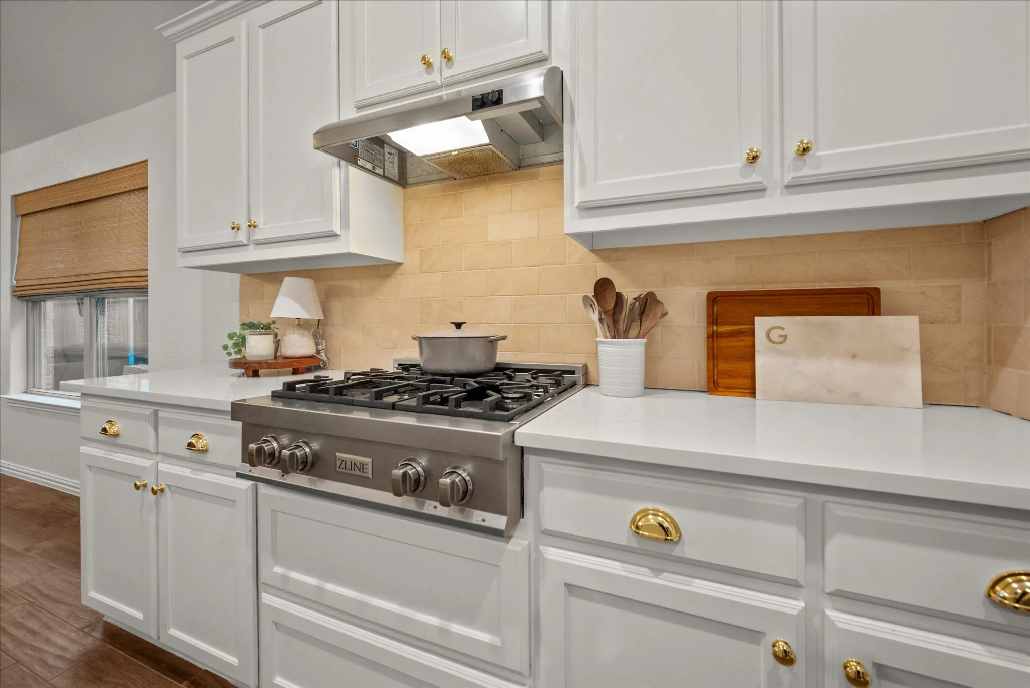 Stainless steel professional-grade range with coordinating vent hood