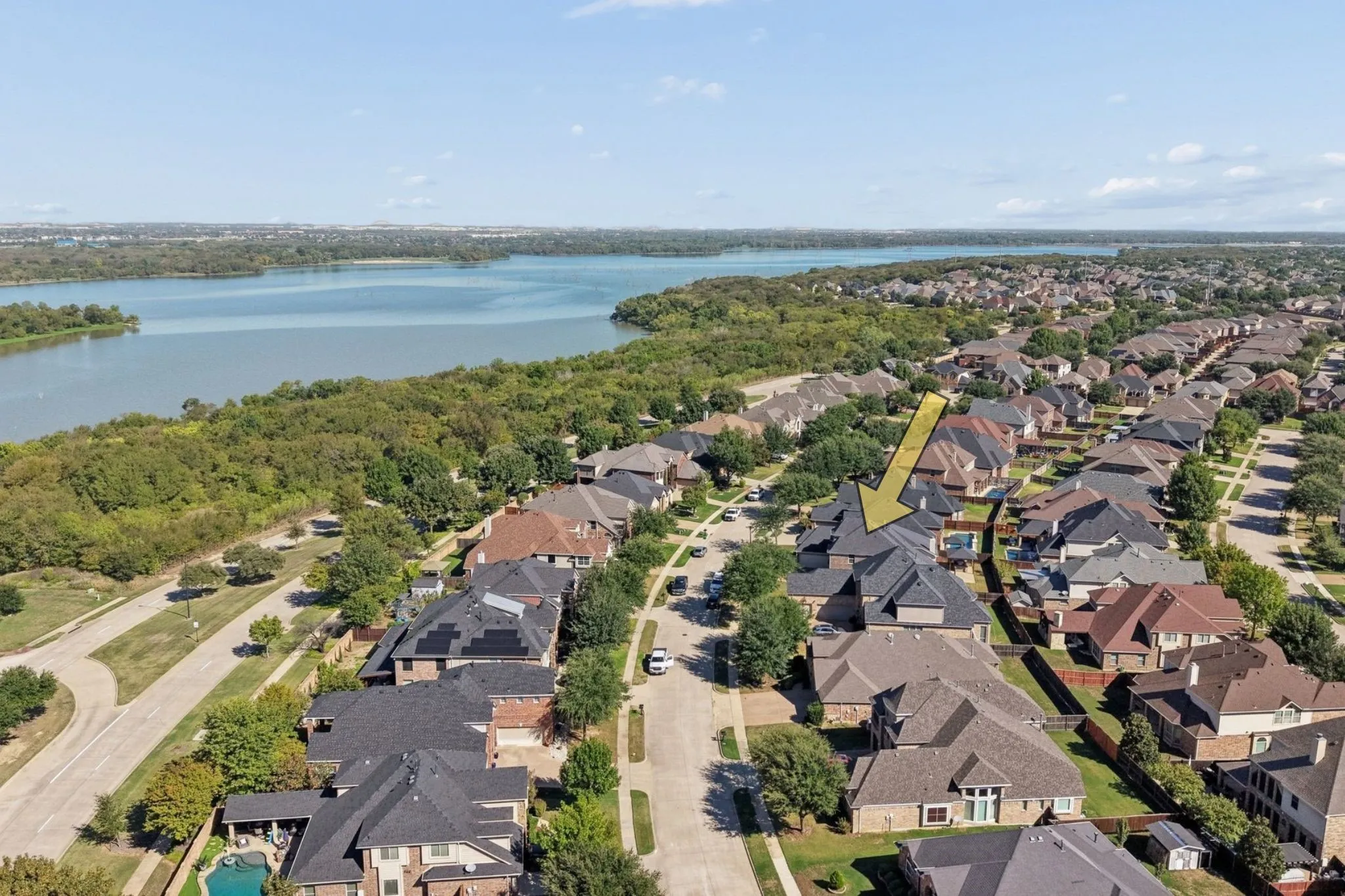 Residential neighborhood with a lake and lush green spaces