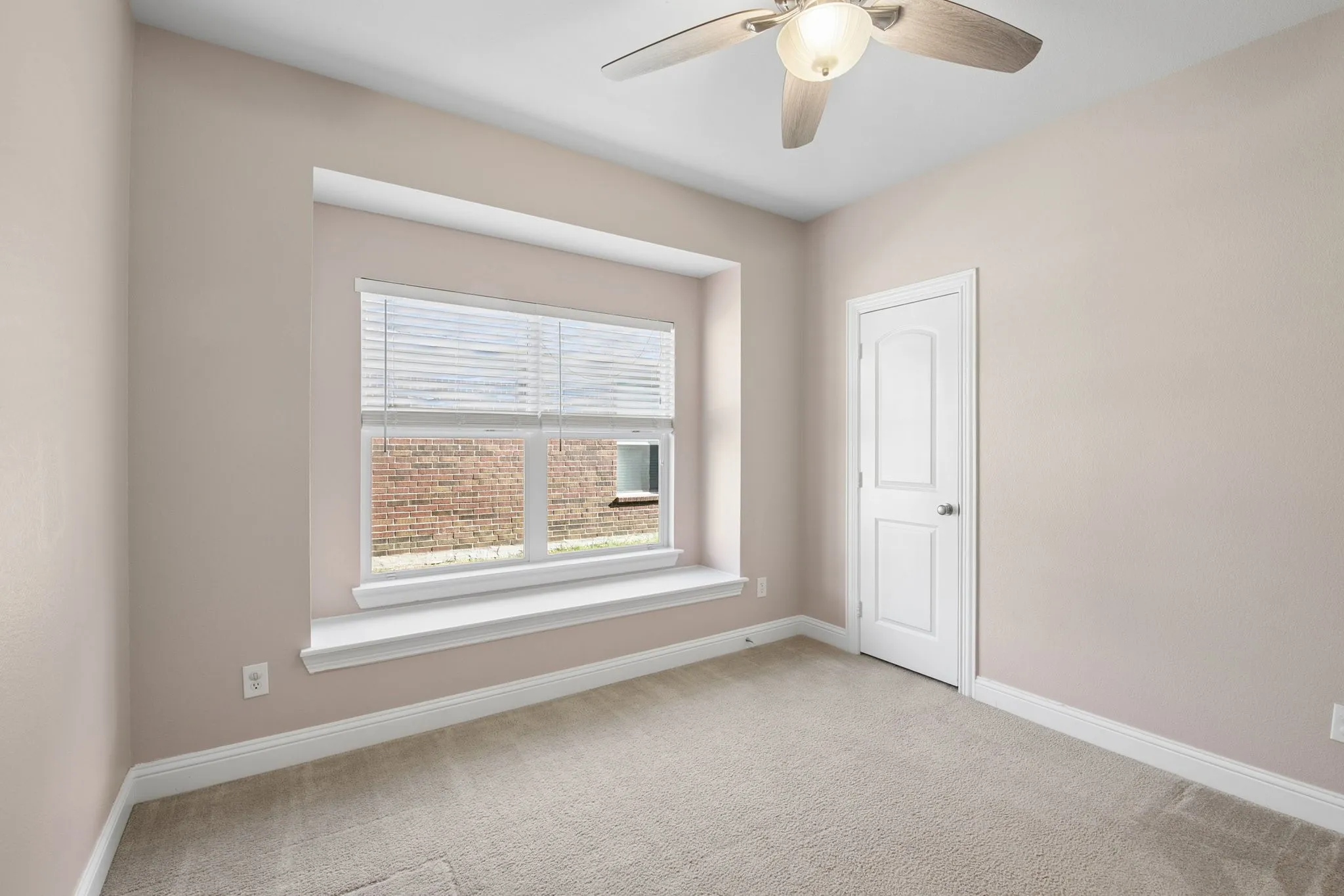 1st Floor 2nd Bedroom with recessed window with a sill, neutral carpet flooring, ceiling fan with integrated lighting, and a paneled interior door