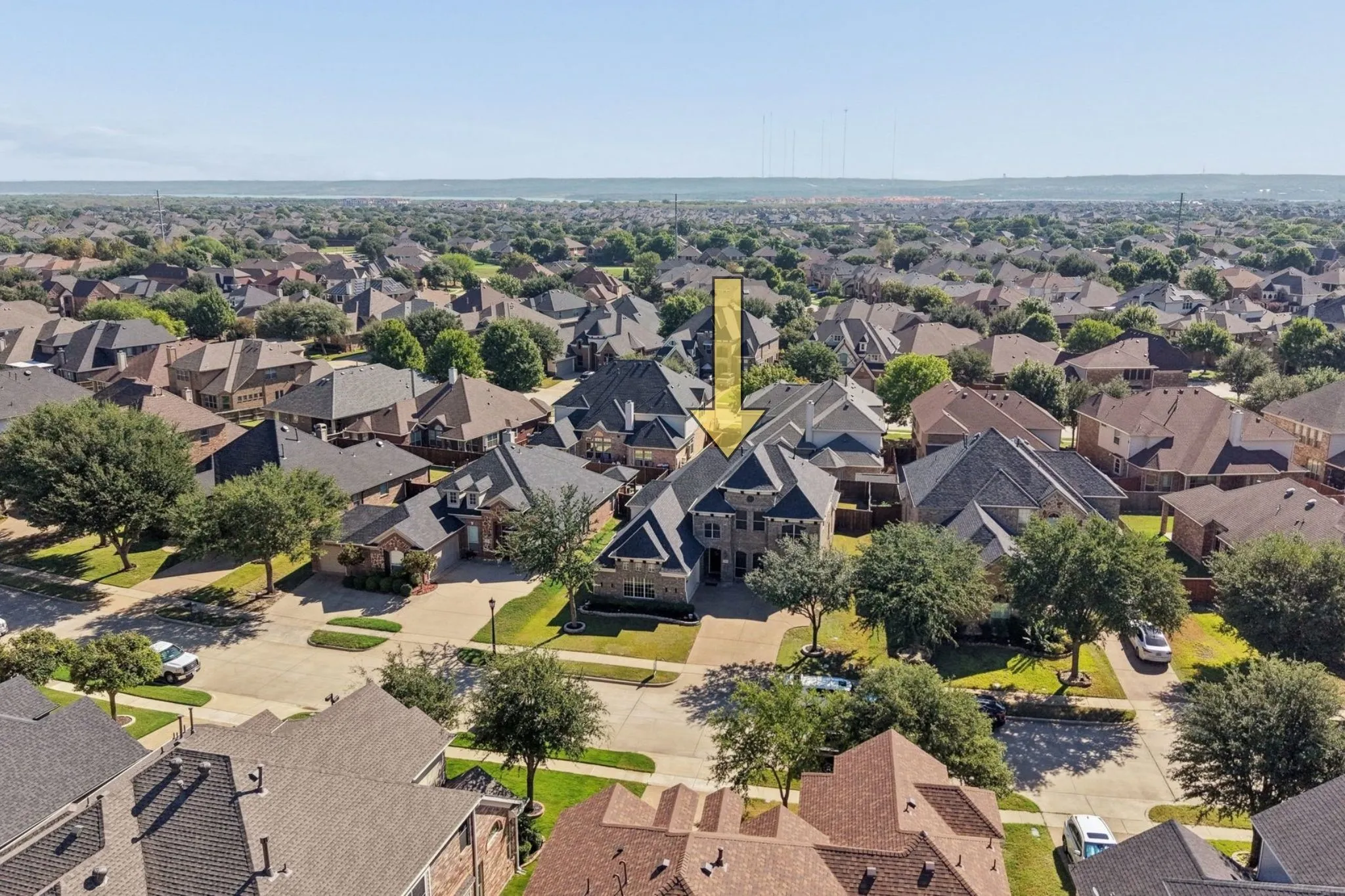 Aerial perspective of a residential neighborhood with varied architectural styles and mature trees