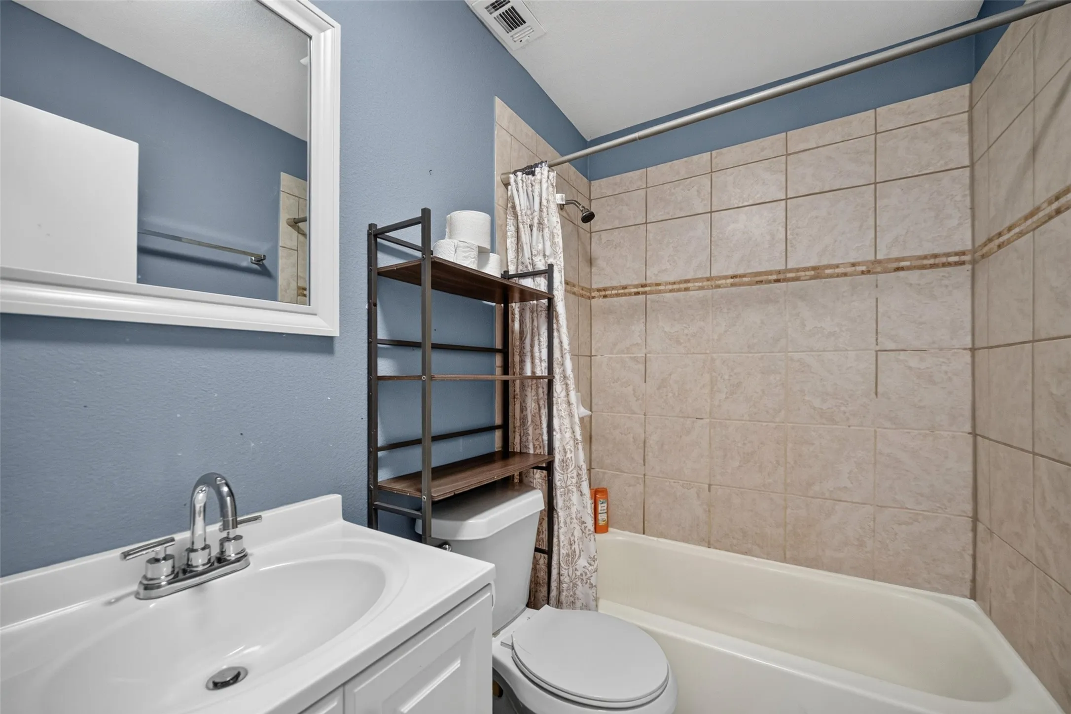 White vanity with integrated sink and chrome faucet