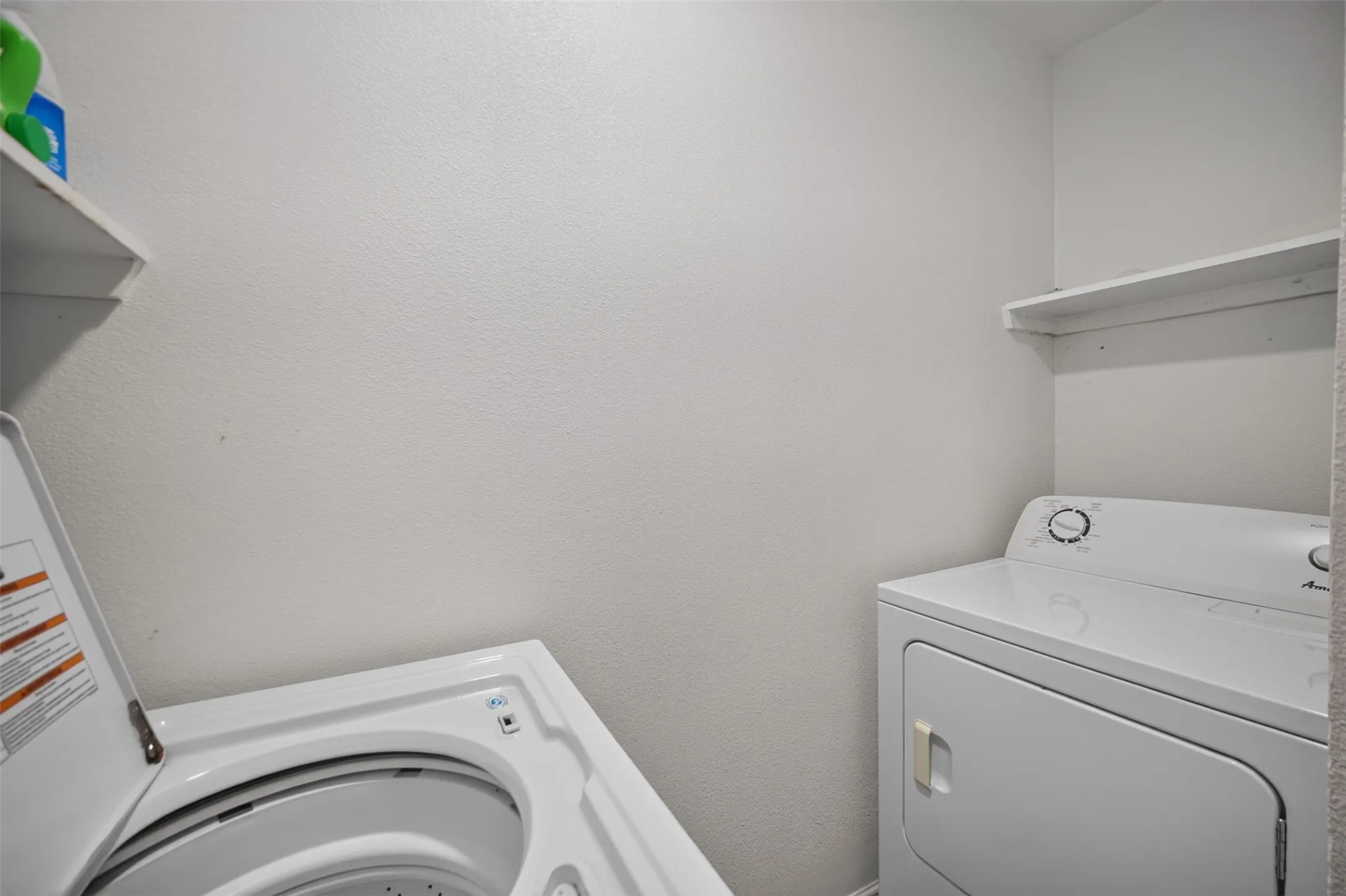 Laundry area with white walls and built-in shelving