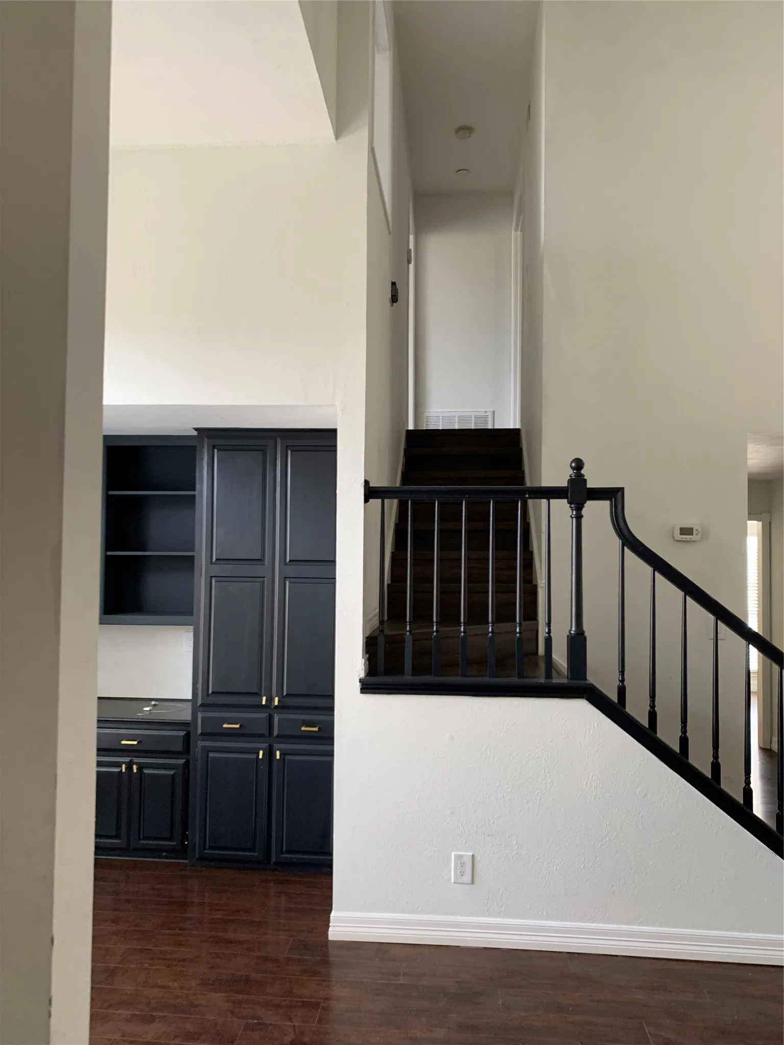 Stairway featuring wood-type flooring