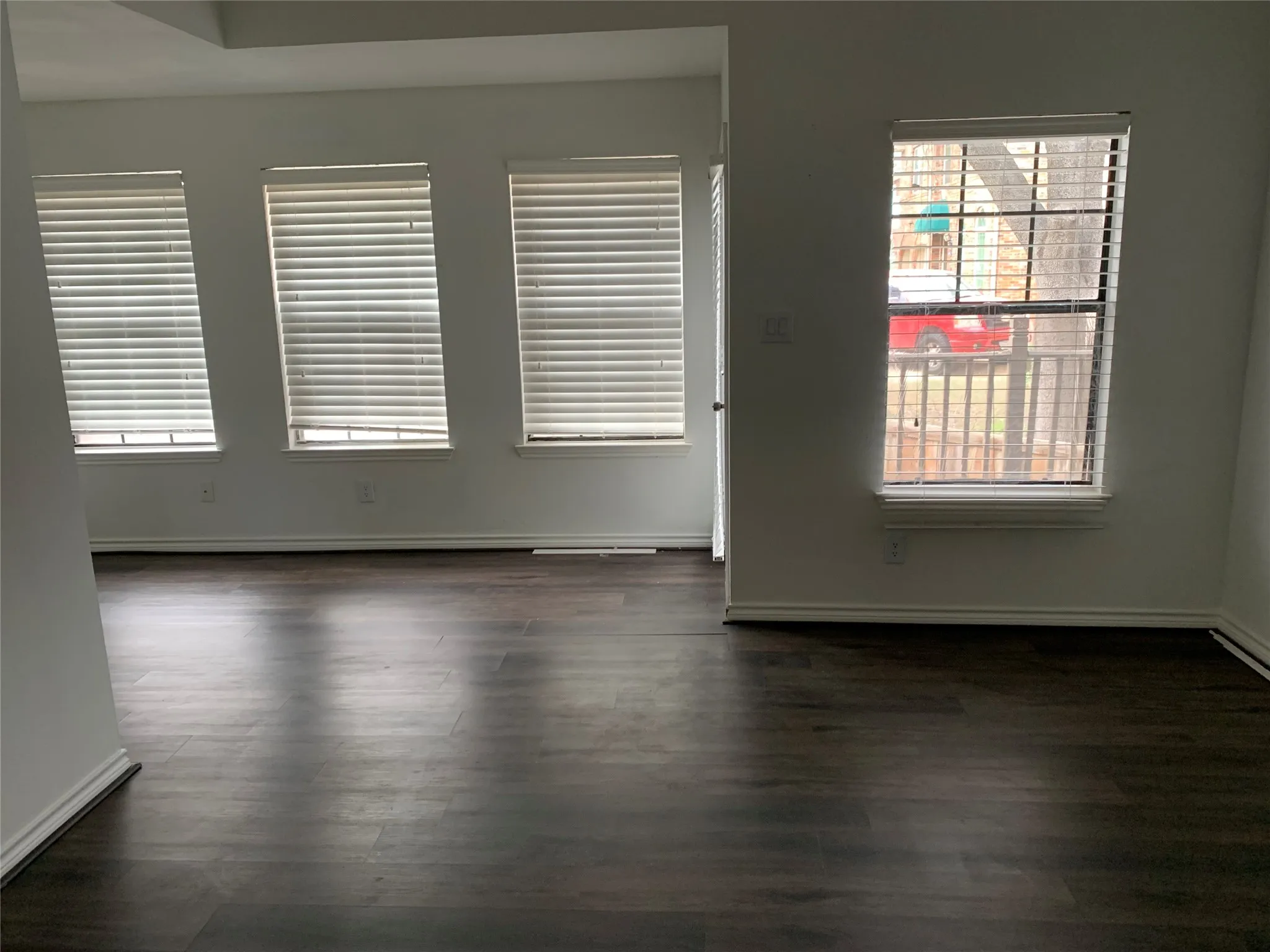 Empty room with dark hardwood / wood-style floors
