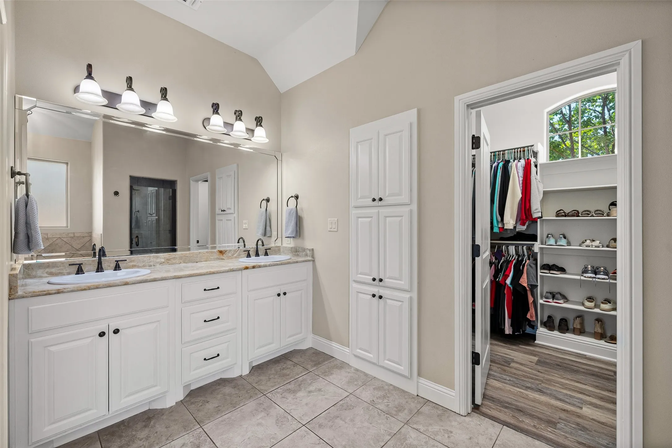 Double vanity with undermount sinks and dark-finish fixtures
