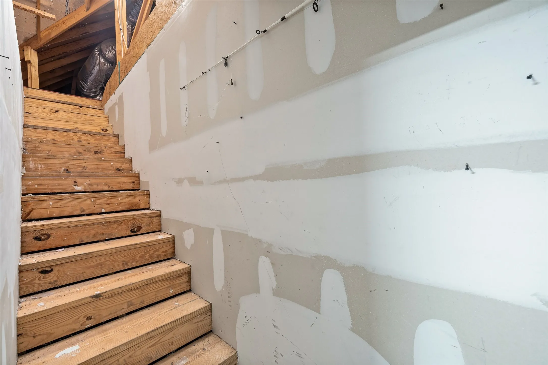 Wood staircase leading to an upper level