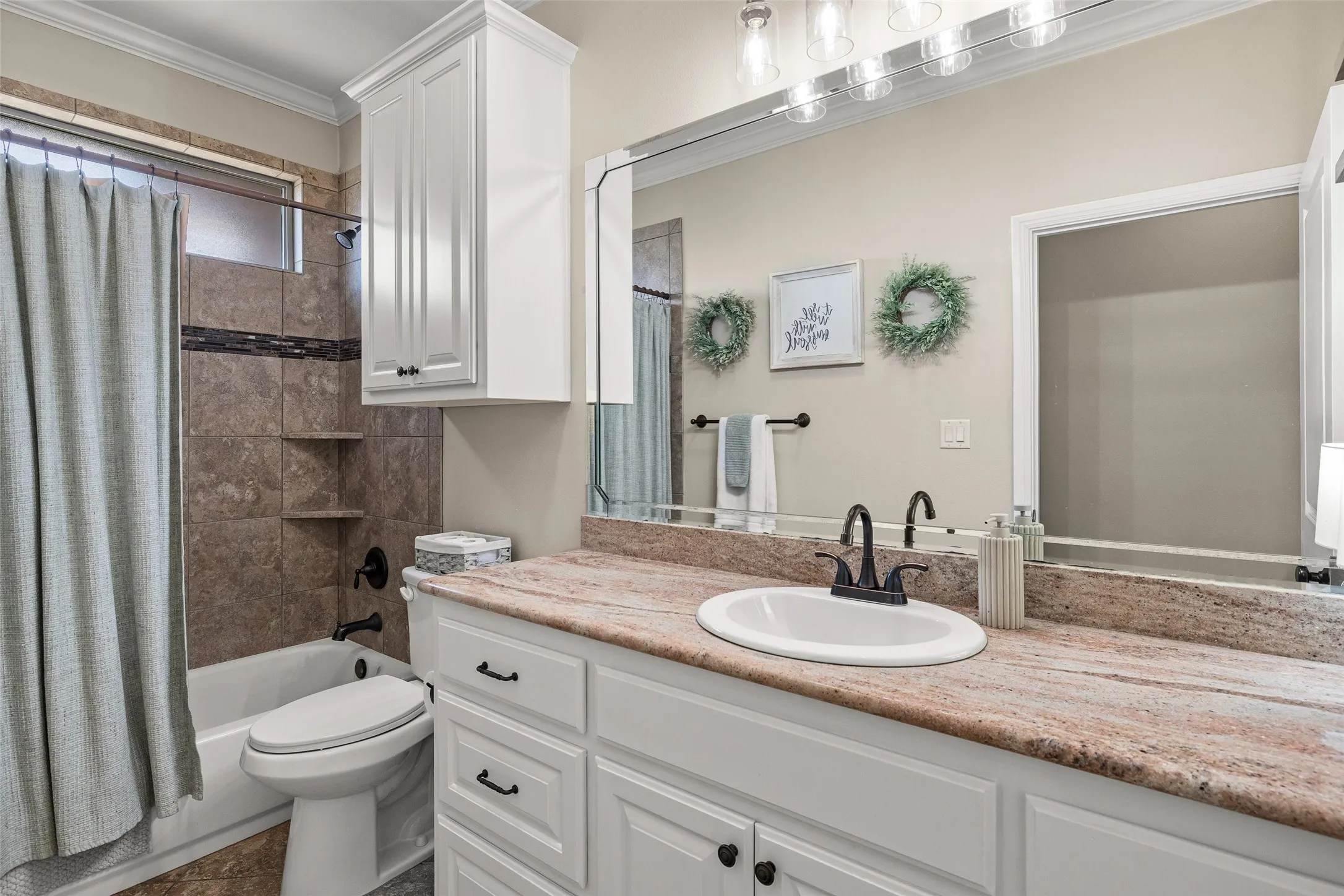 White shaker-style vanity with a single basin and matte black fixtures