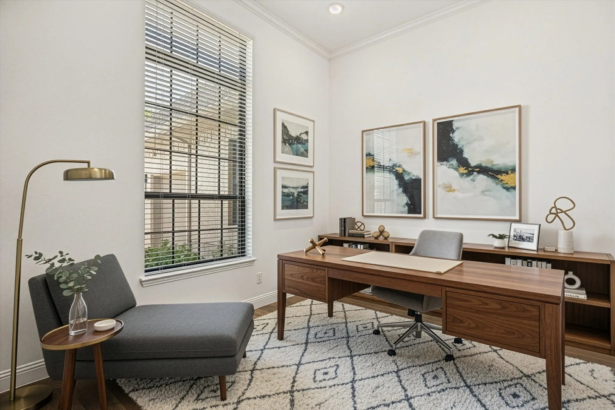 office/bedroom.  virtual staging as an offife  Vaulted ceiling with crown molding, large window with blinds, wood-finish flooring, built-in shelving, and wood-finish desk