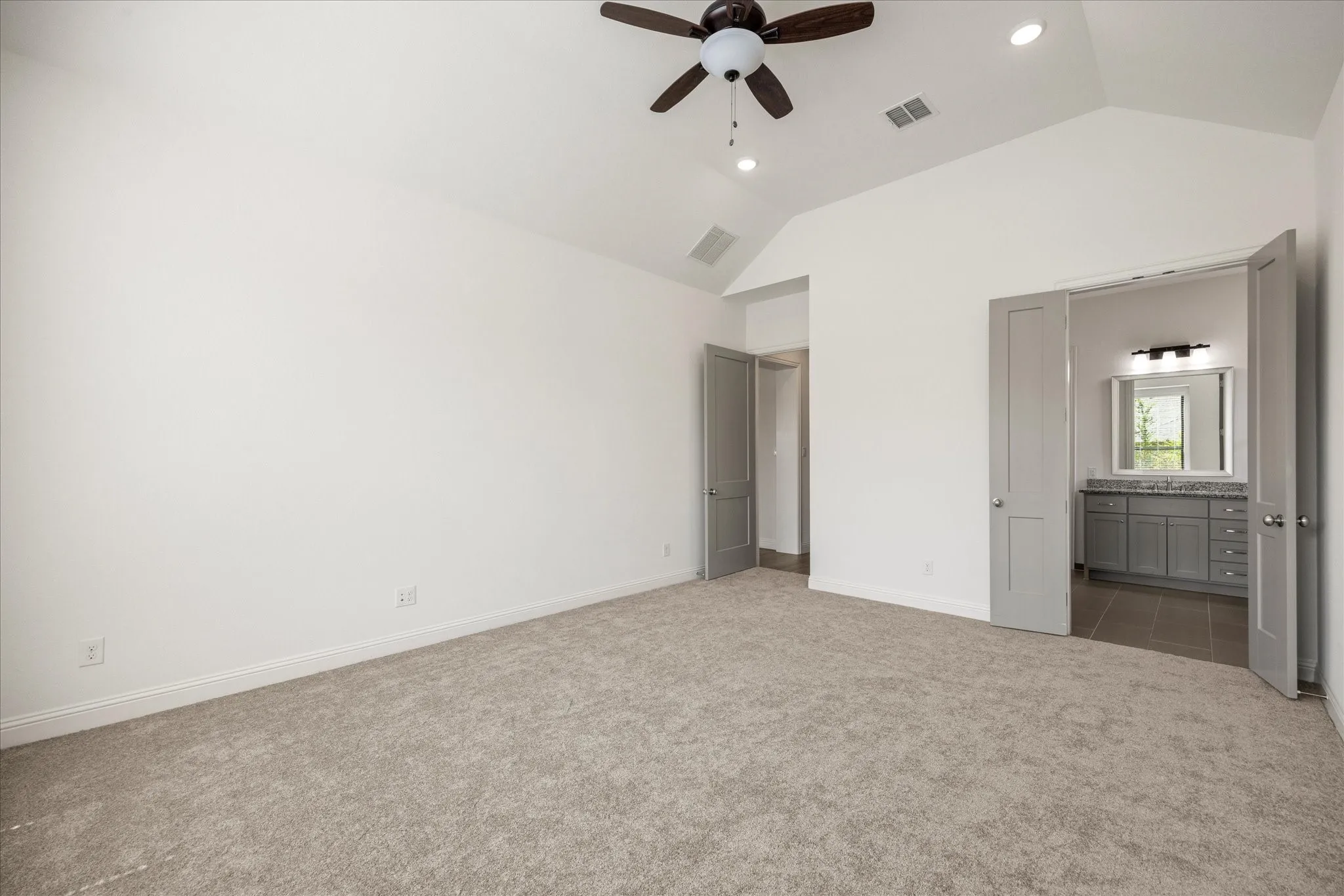 Vaulted ceiling with a ceiling fan and recessed lighting