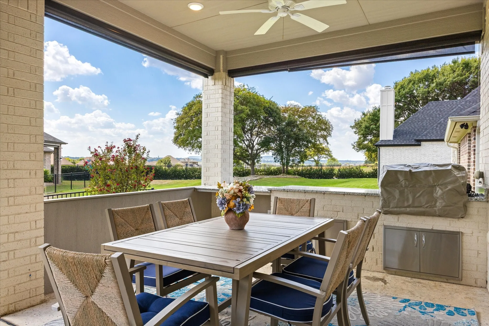 Covered patio featuring a ceiling fan, recessed lighting, and brick columns