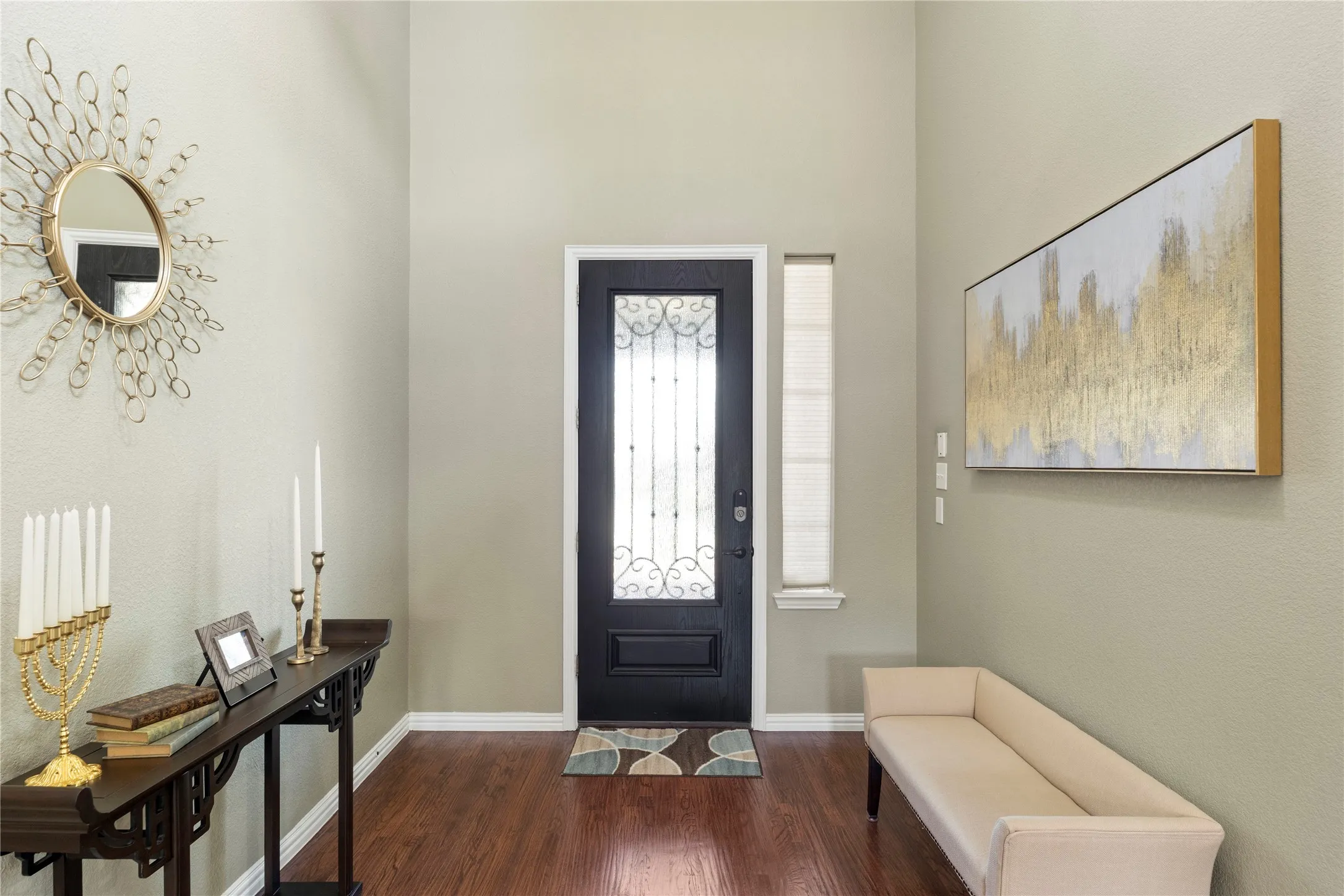 Entryway featuring a dark wood-finish door with decorative glass, a sidelight window, and hardwood flooring