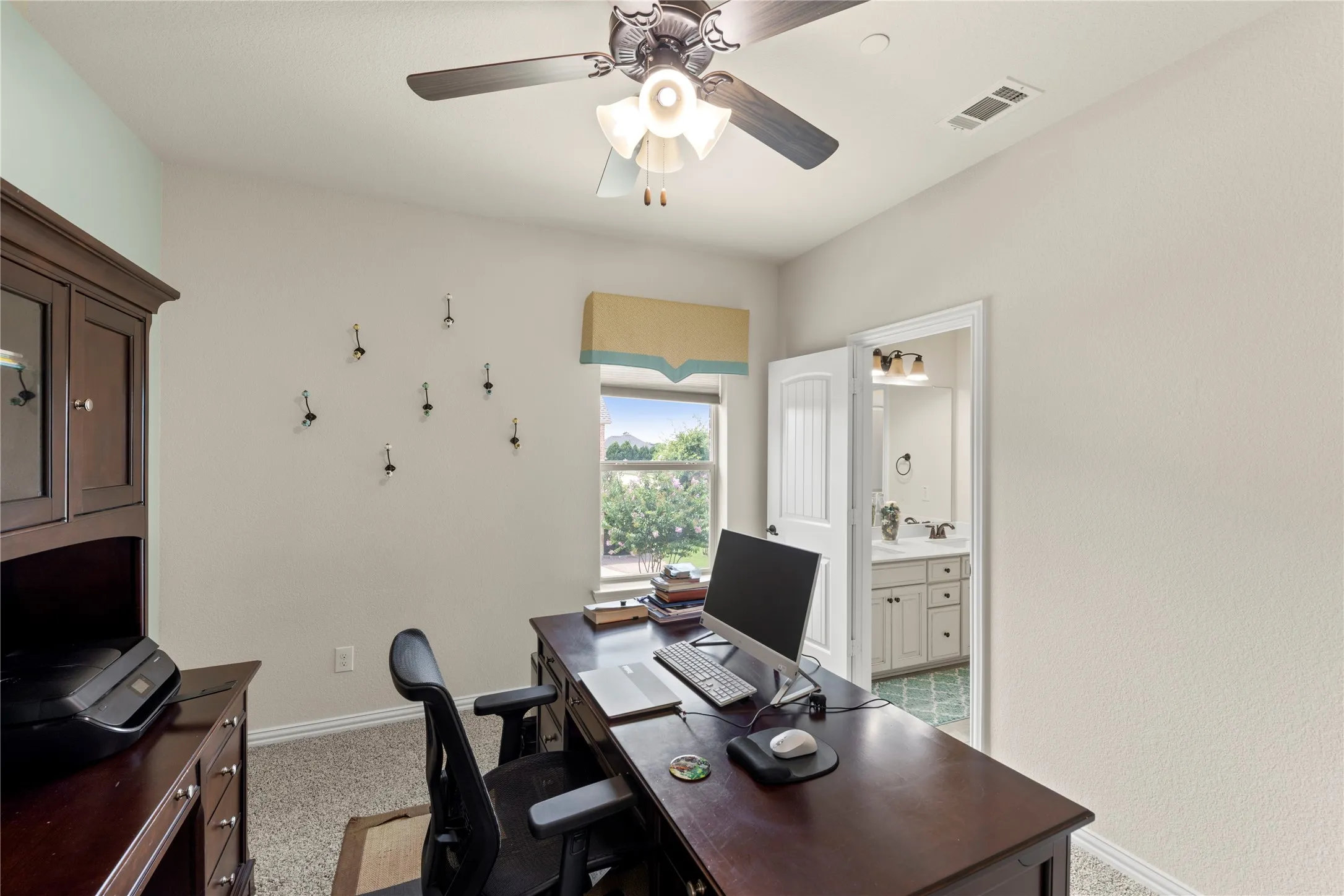 Room featuring a window, ceiling fan, and carpet flooring