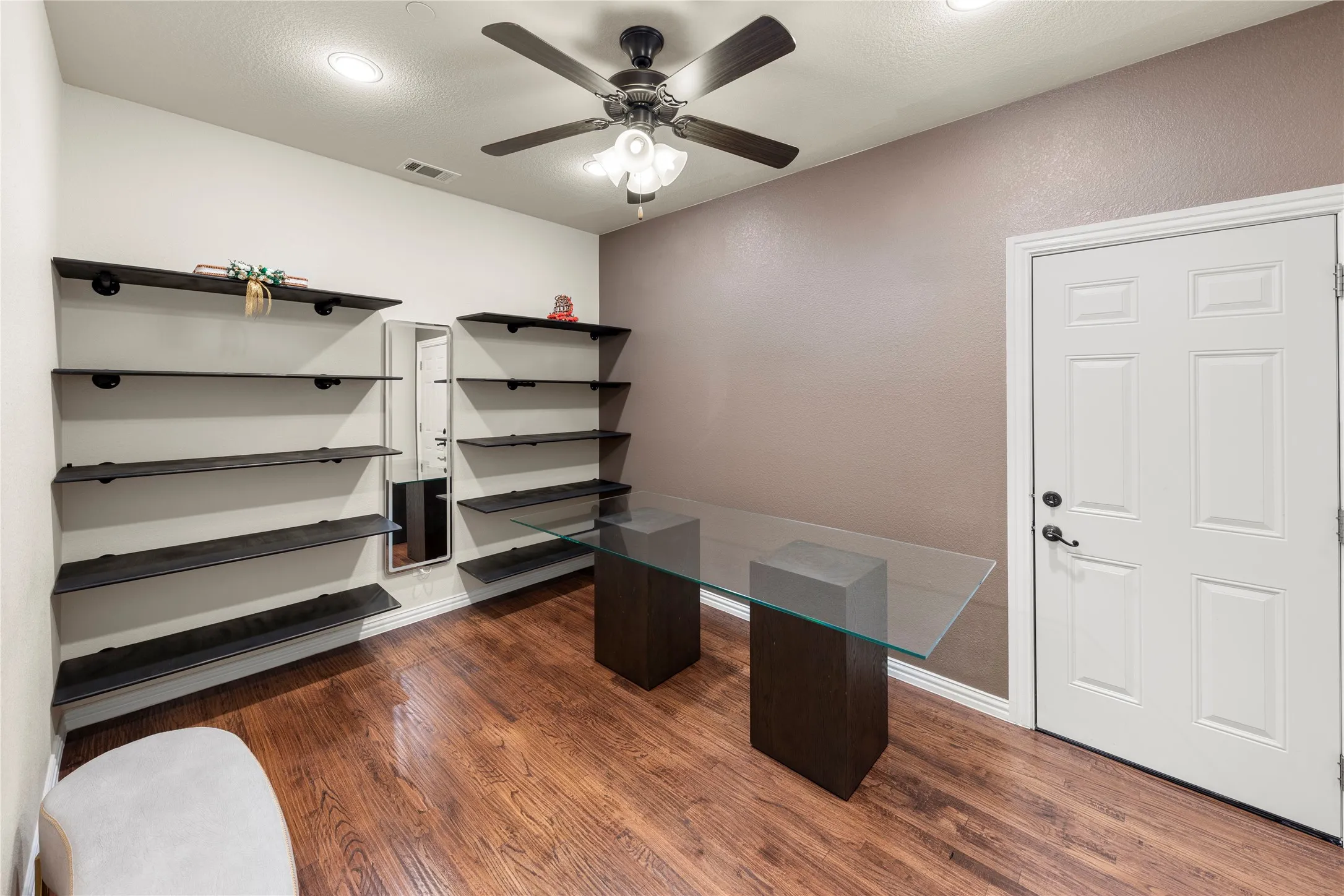 Room featuring wood-finish flooring, recessed lighting, and a ceiling fan