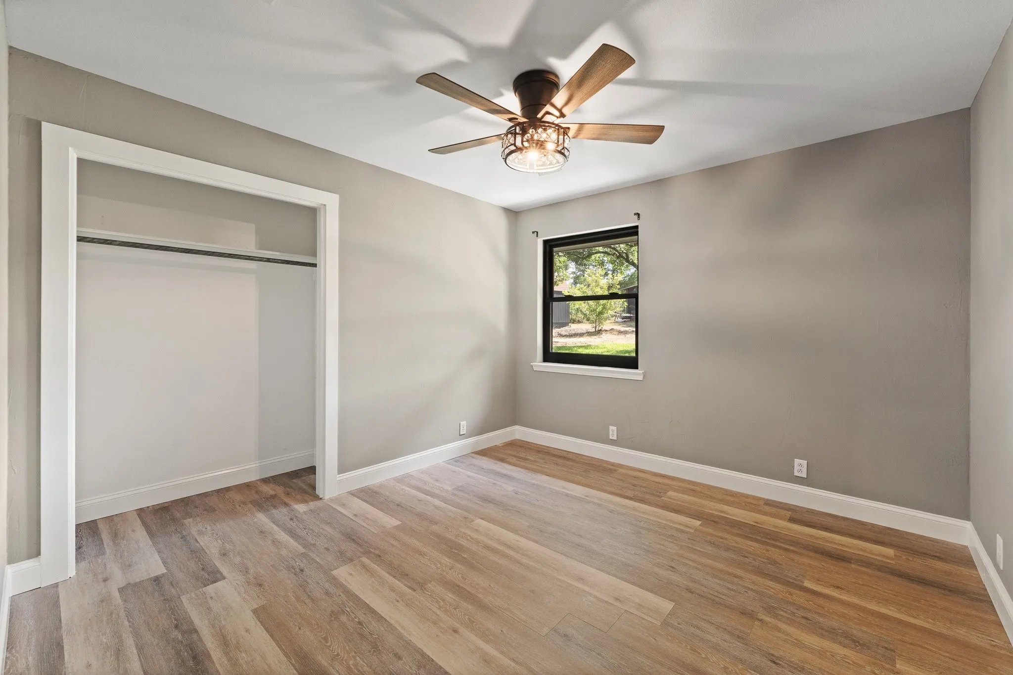 Secondary bedroom #1. NEW FLOORING & CEILING FAN!