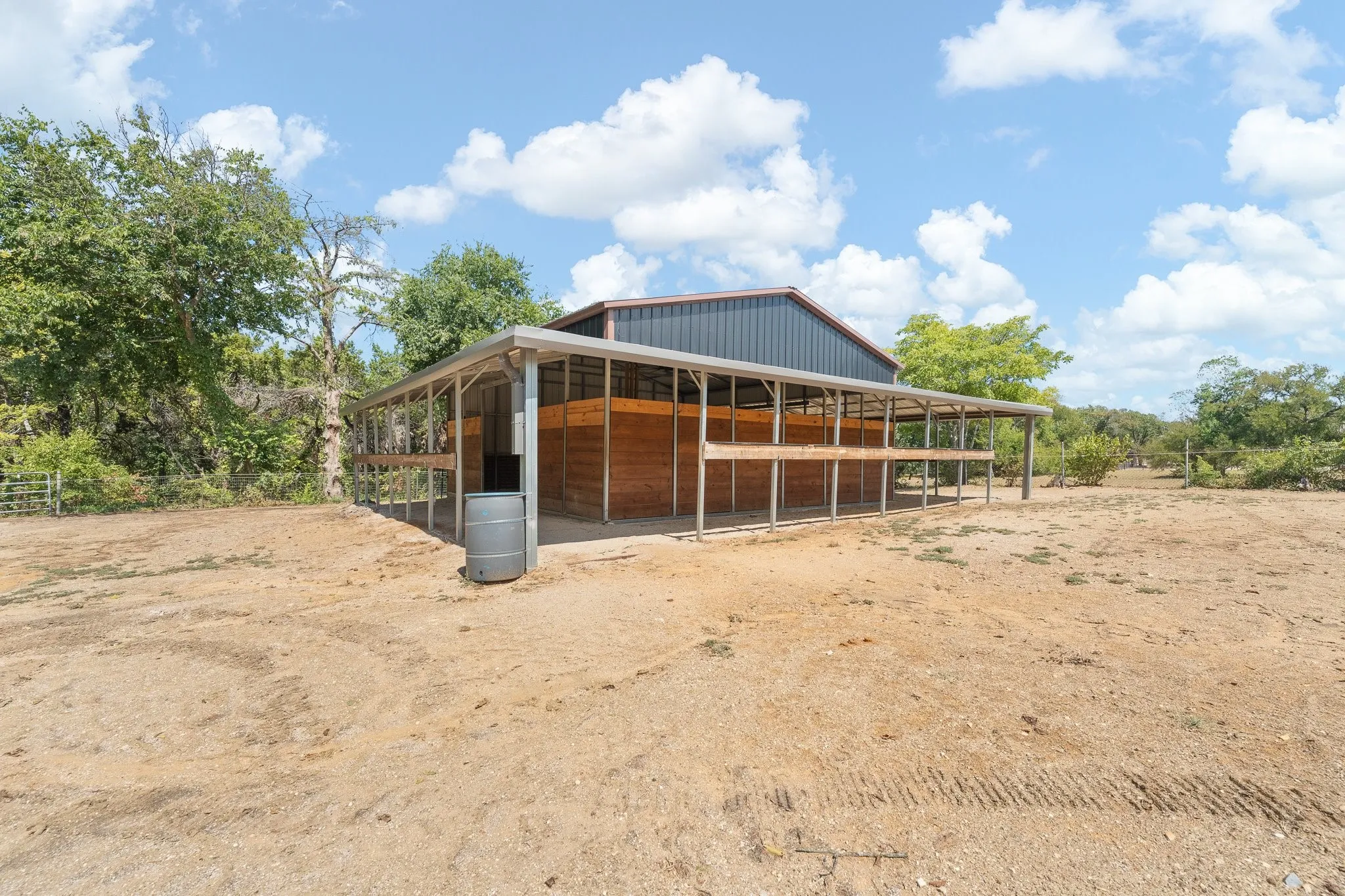 30x30x12 barn w concrete slab, electric, ceiling lights & large ceiling fan. The barn OPENS UP INTO THE TURN OUT FOR ADDED CONVENIENCE!
