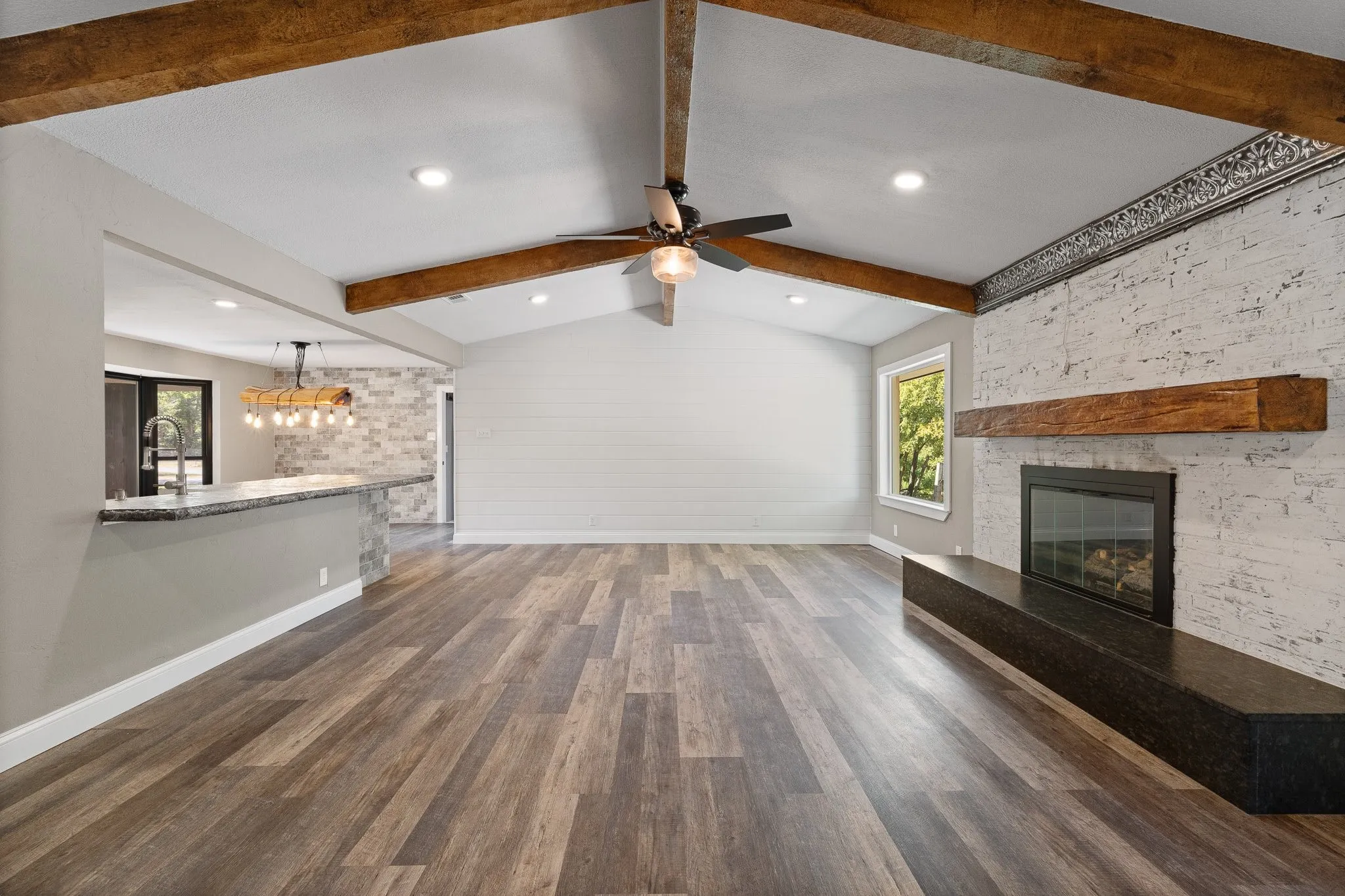 The living room is overlooked by the kitchen and dining area, plus it is also equipped with a GAS FIREPLACE.
