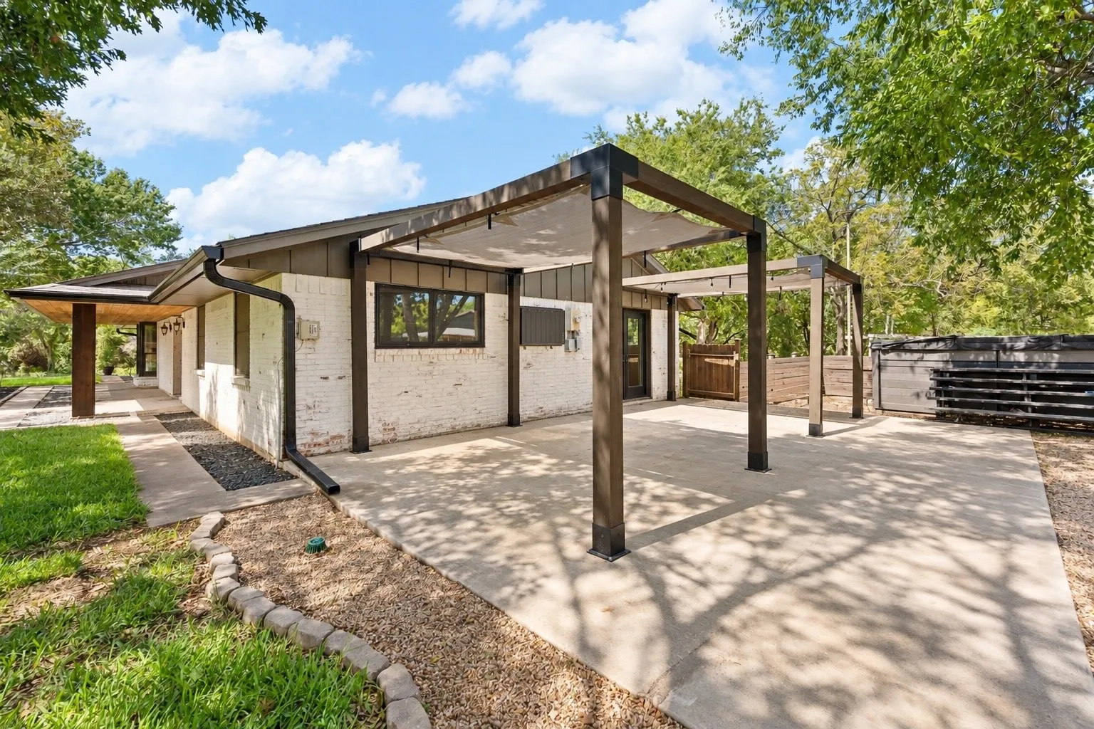 COVERED BACK PATIO with primary bedroom access! Extended concrete slab and 2 covered seating areas! This area has the BEST view of the barn!