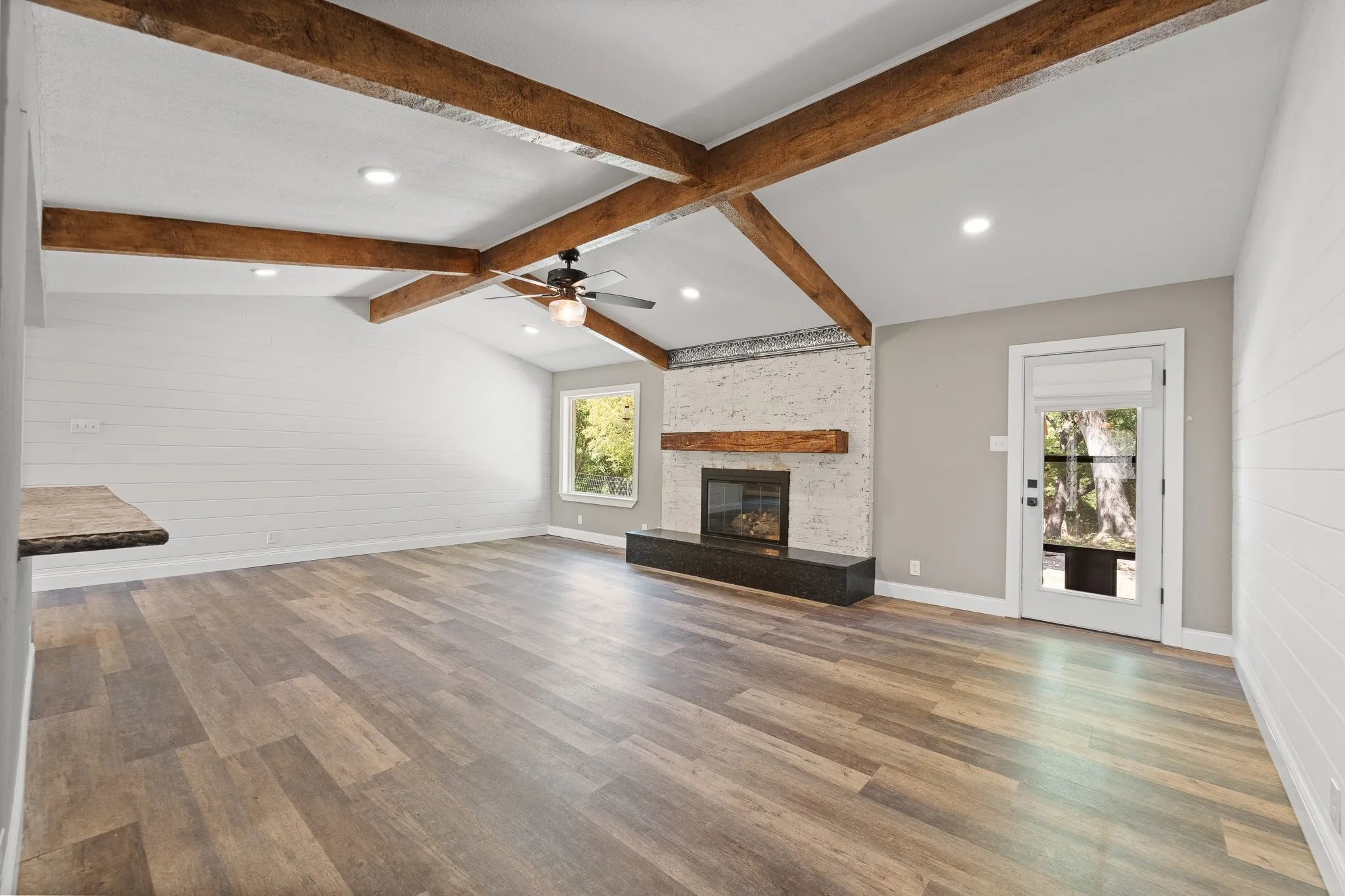 After walking in, you are immediately welcomed with high ceilings, wooden beams, and plenty of natural light! The living room is conveniently equipped with backyard access, leading you to the covered pergola or the BARN!