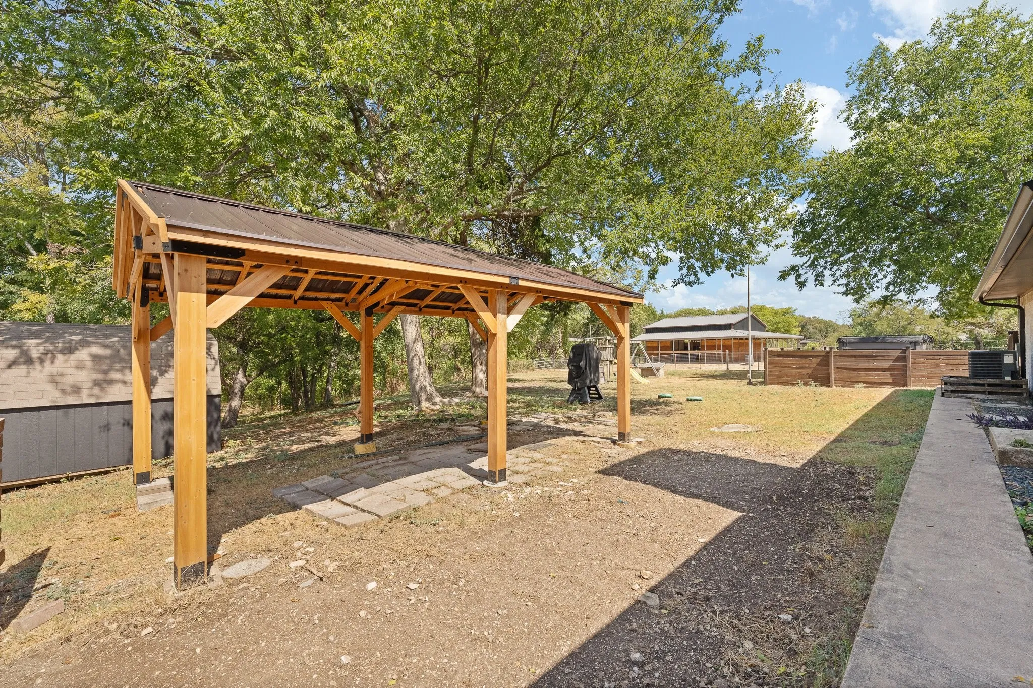 Backyard pergola conveniently overlooking the Atlas Swim Spa & barn, perfect for entertaining, relaxing, or keeping an eye on the animals & kids!
