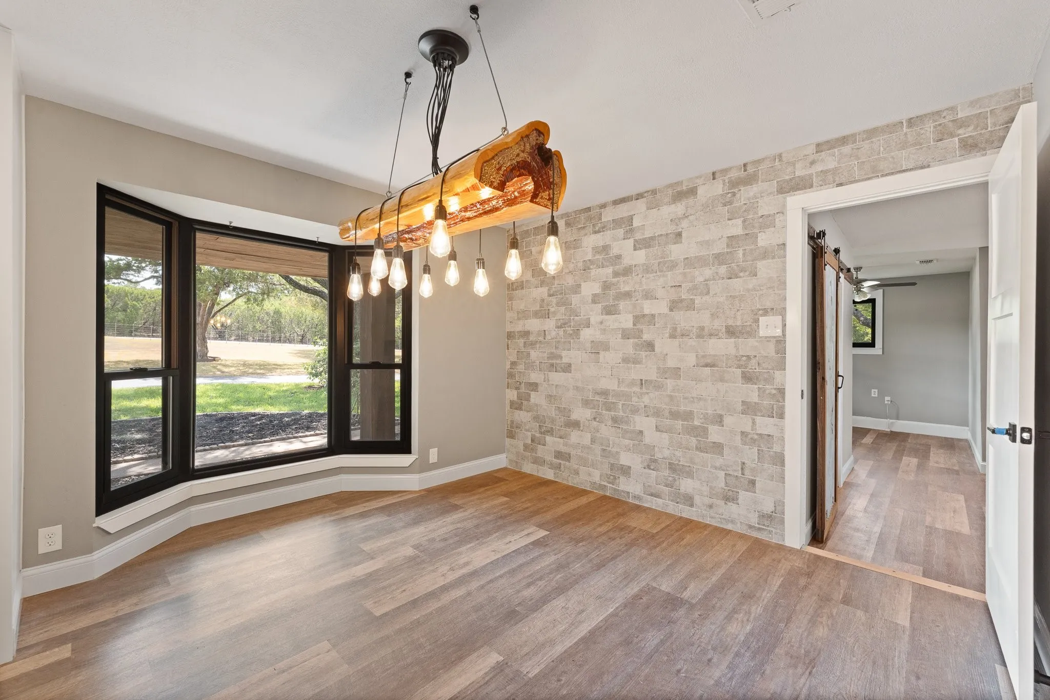 Dining area which has the best view of the wooded front yard!! There is also access to the BONUS SPACE, pictured on the right.
