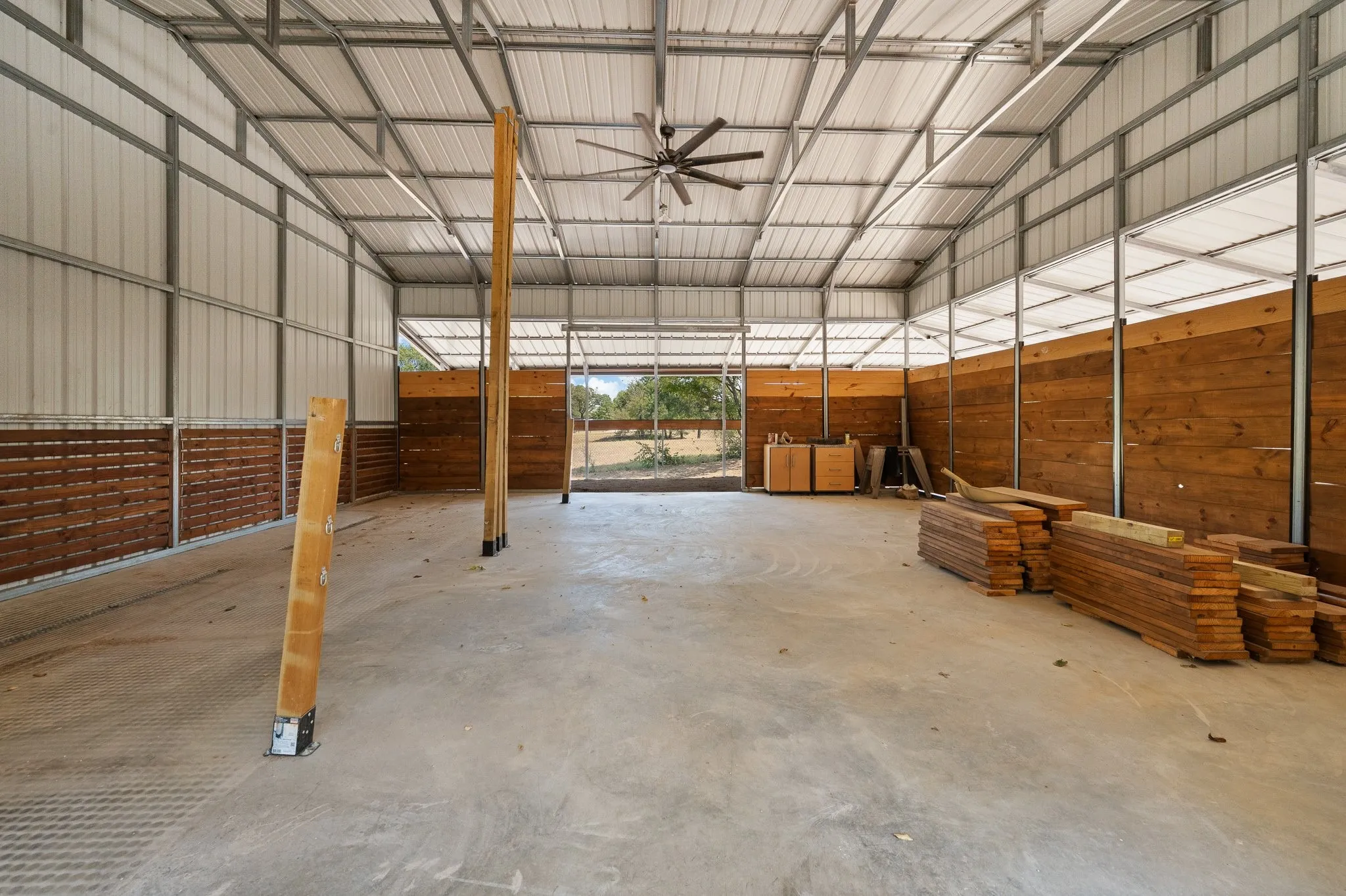 CONCRETE SLAB!!! AND LARGE CEILING FAN!! This space could easily be converted into multiple stalls, a WORKSHOP, or MAN CAVE!!!
