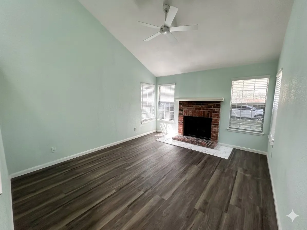 Wood-finish flooring, vaulted ceiling, and ceiling fan