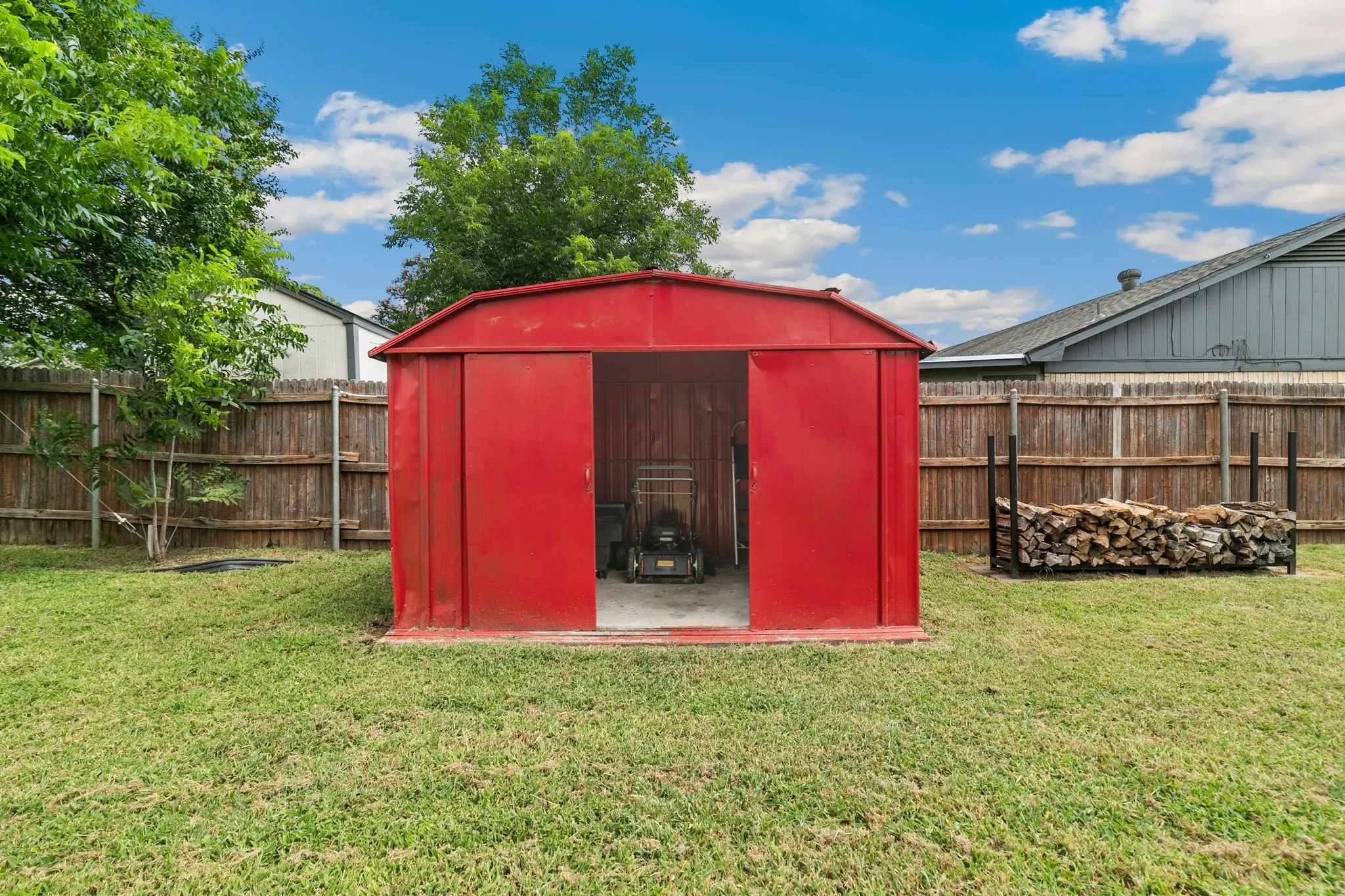 Red metal storage shed with an open doorway