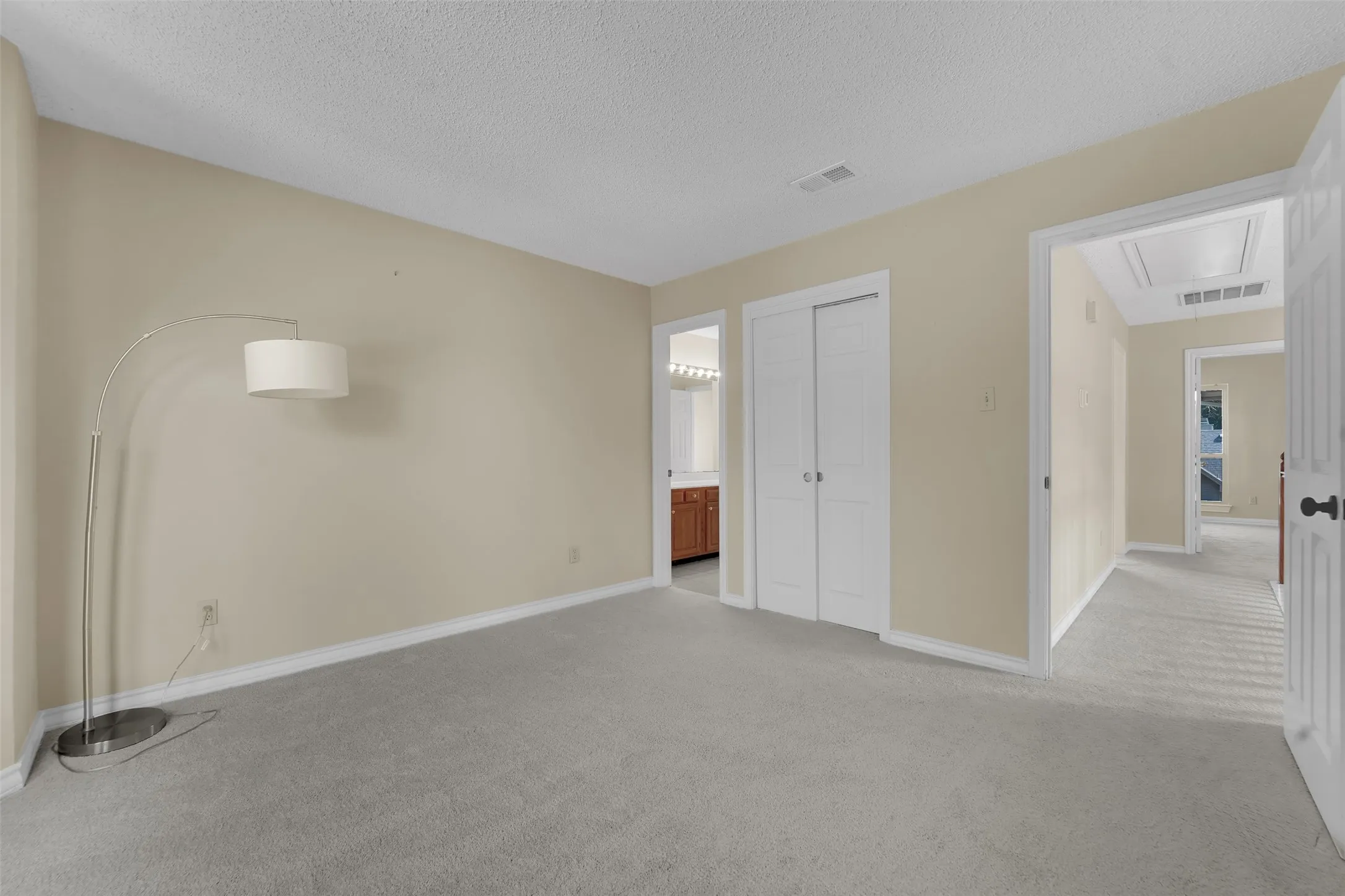 Plush carpeting, neutral wall color, and white trim throughout