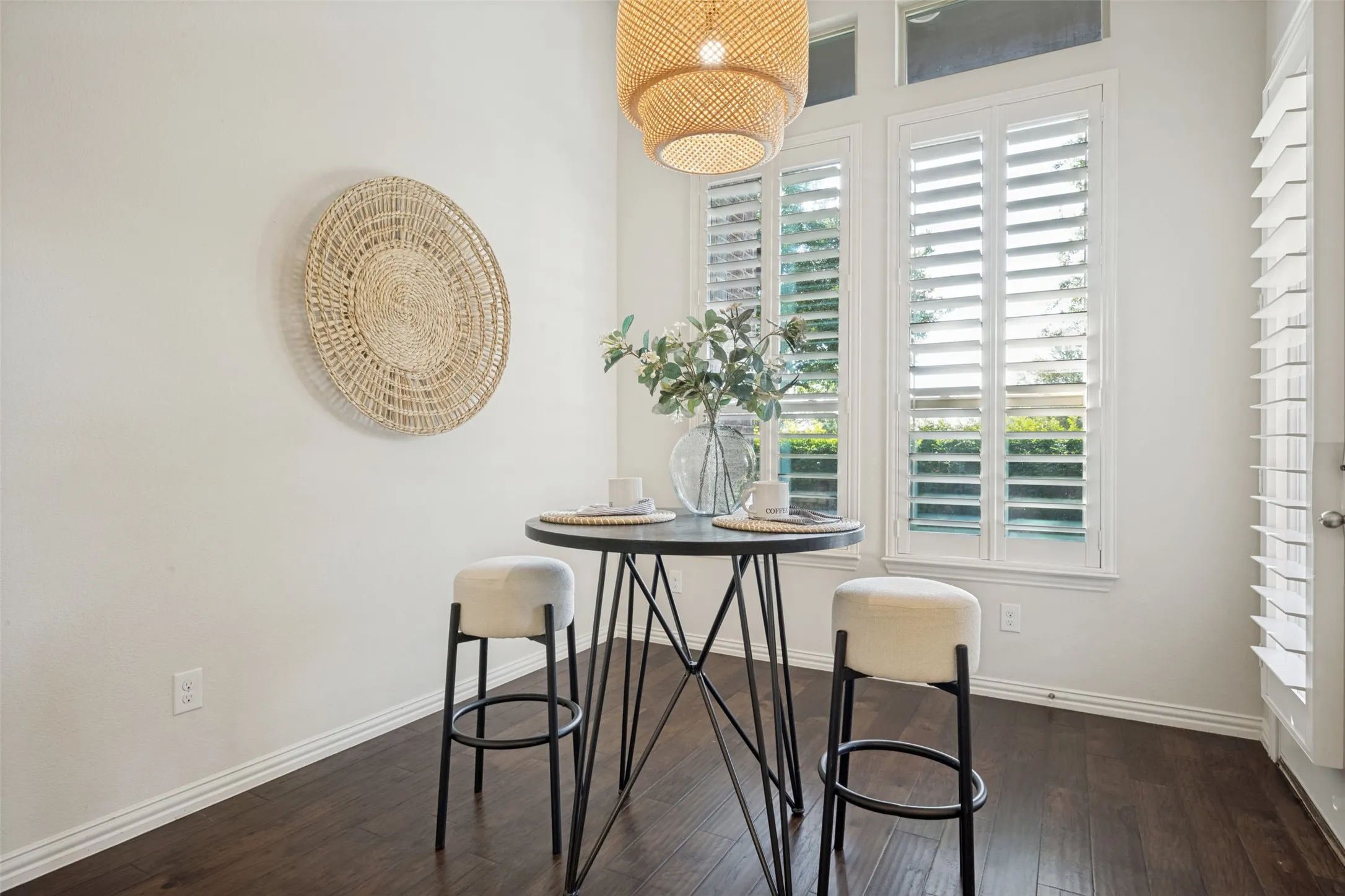 Hardwood-finish flooring, white walls, and bright white window shutters