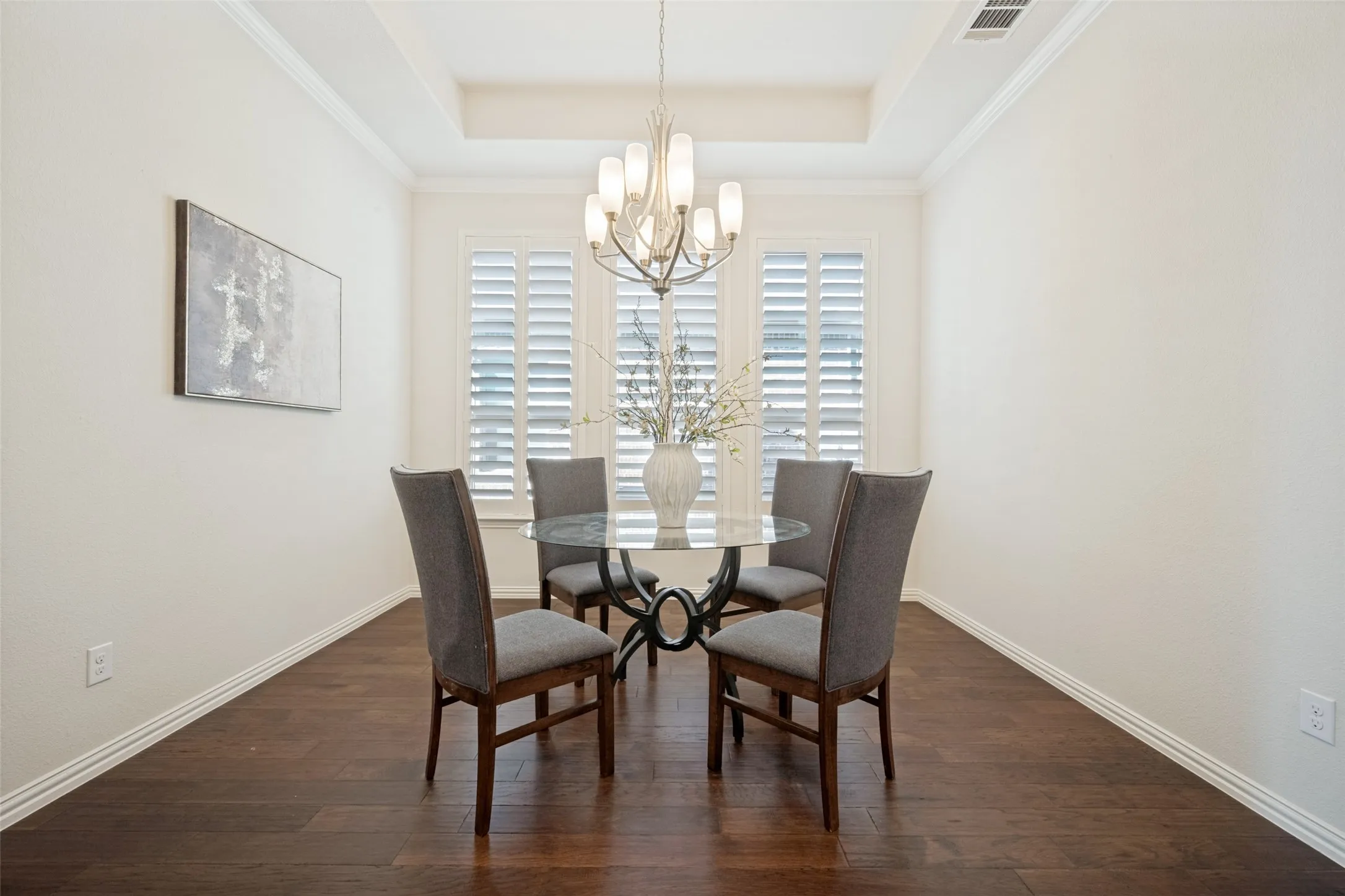 Wood-finish flooring, crown molding, and plantation shutters