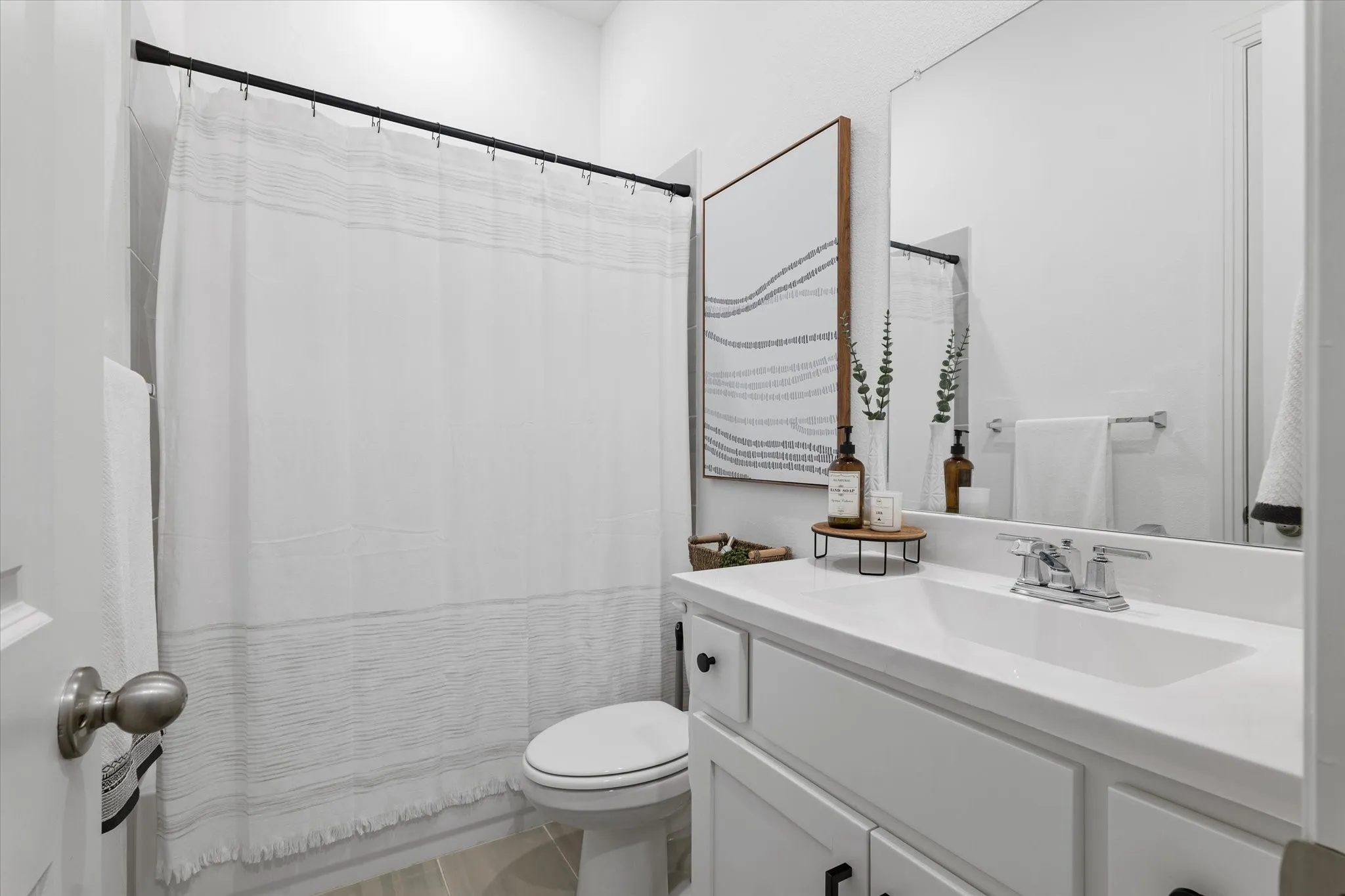 Vanity with an integrated sink, polished chrome faucet, and ample storage beneath