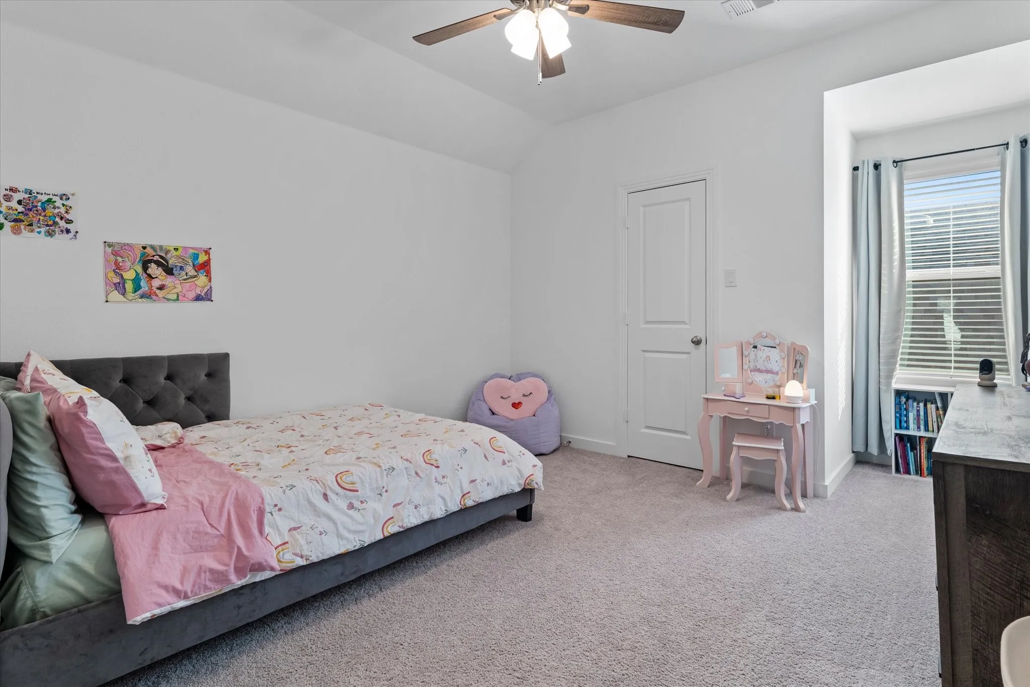 Recessed window alcove with integrated shelving, ceiling fan, and light gray carpeted flooring