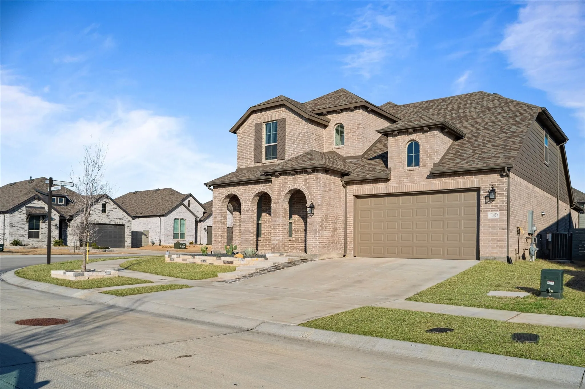 Brick exterior with arched entryway and multiple gables