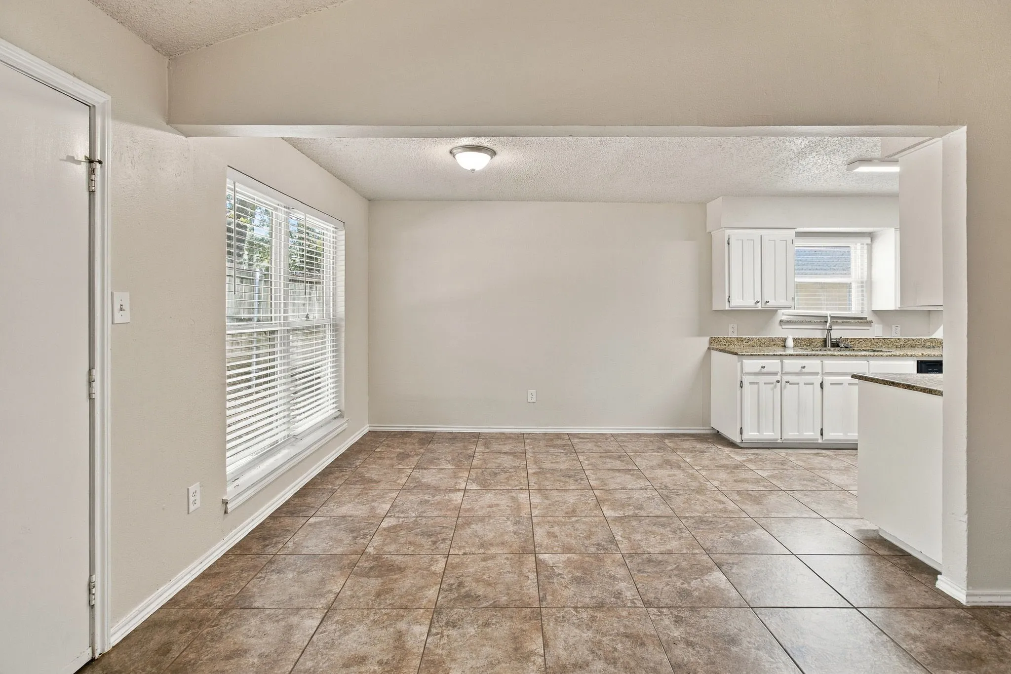 Ceramic tile flooring throughout, white interior paint, and a double window with blinds