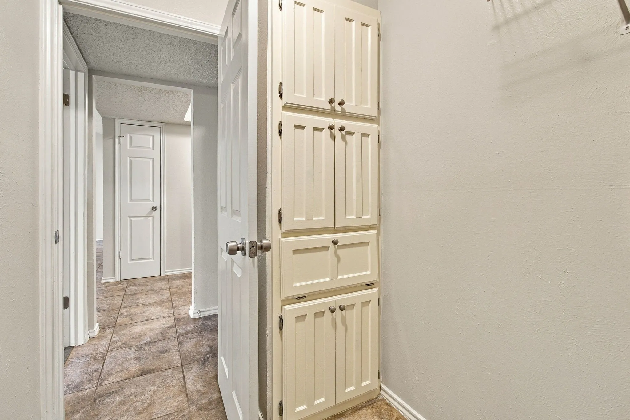 Built-in cabinetry, tile flooring, and neutral wall finishes