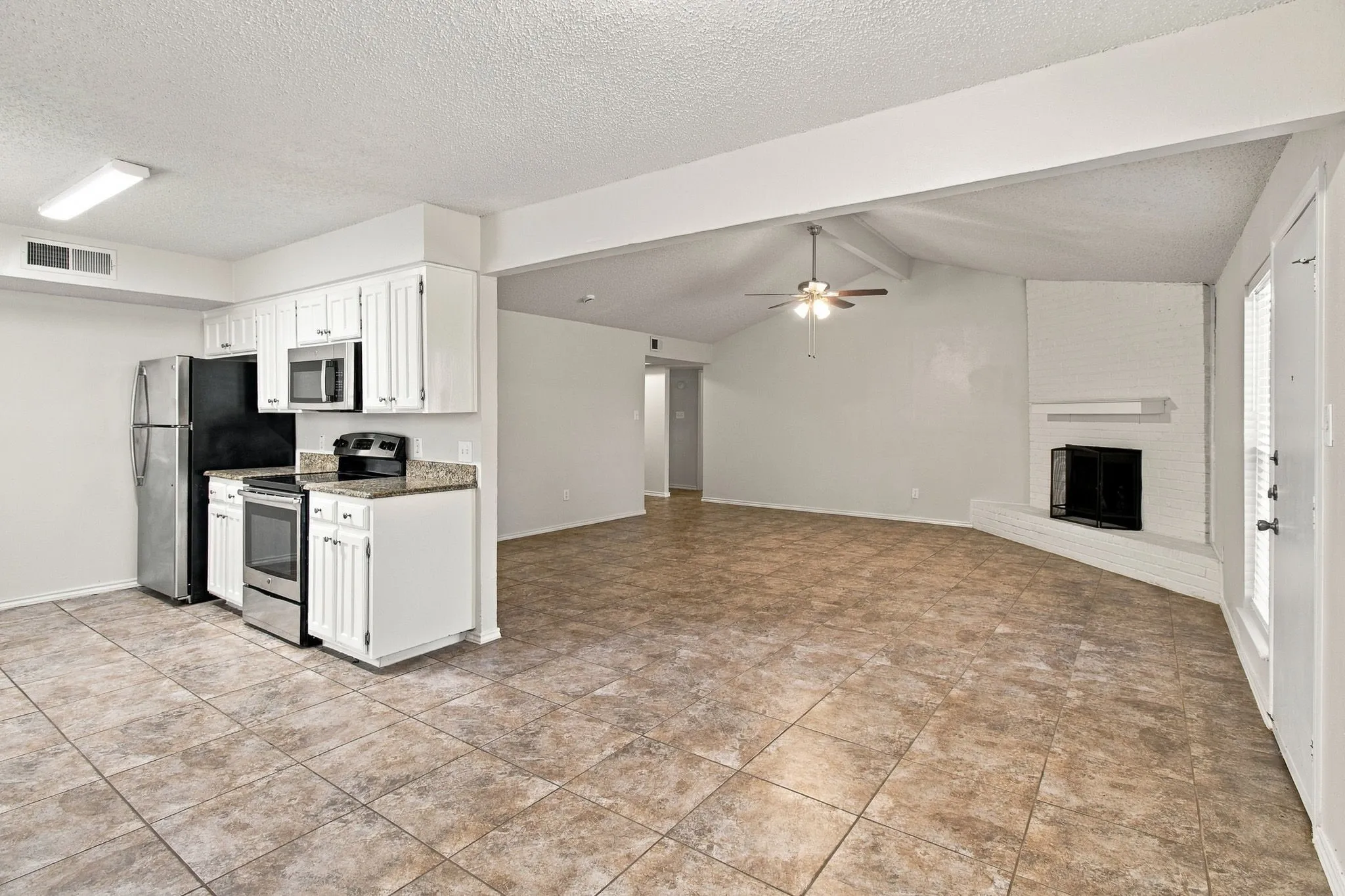 Kitchen featuring white cabinetry and stainless steel appliances