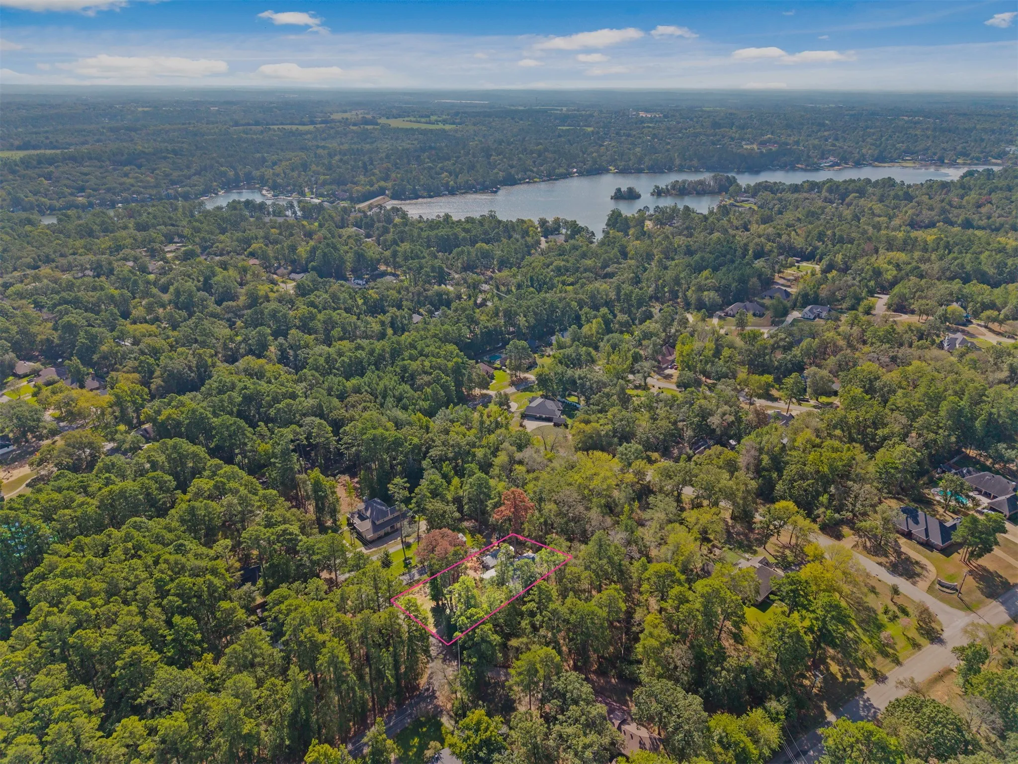 Expansive wooded property with a substantial body of water in the background