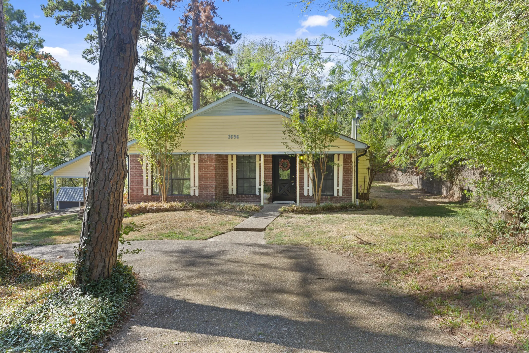 Brick and siding exterior with mature trees