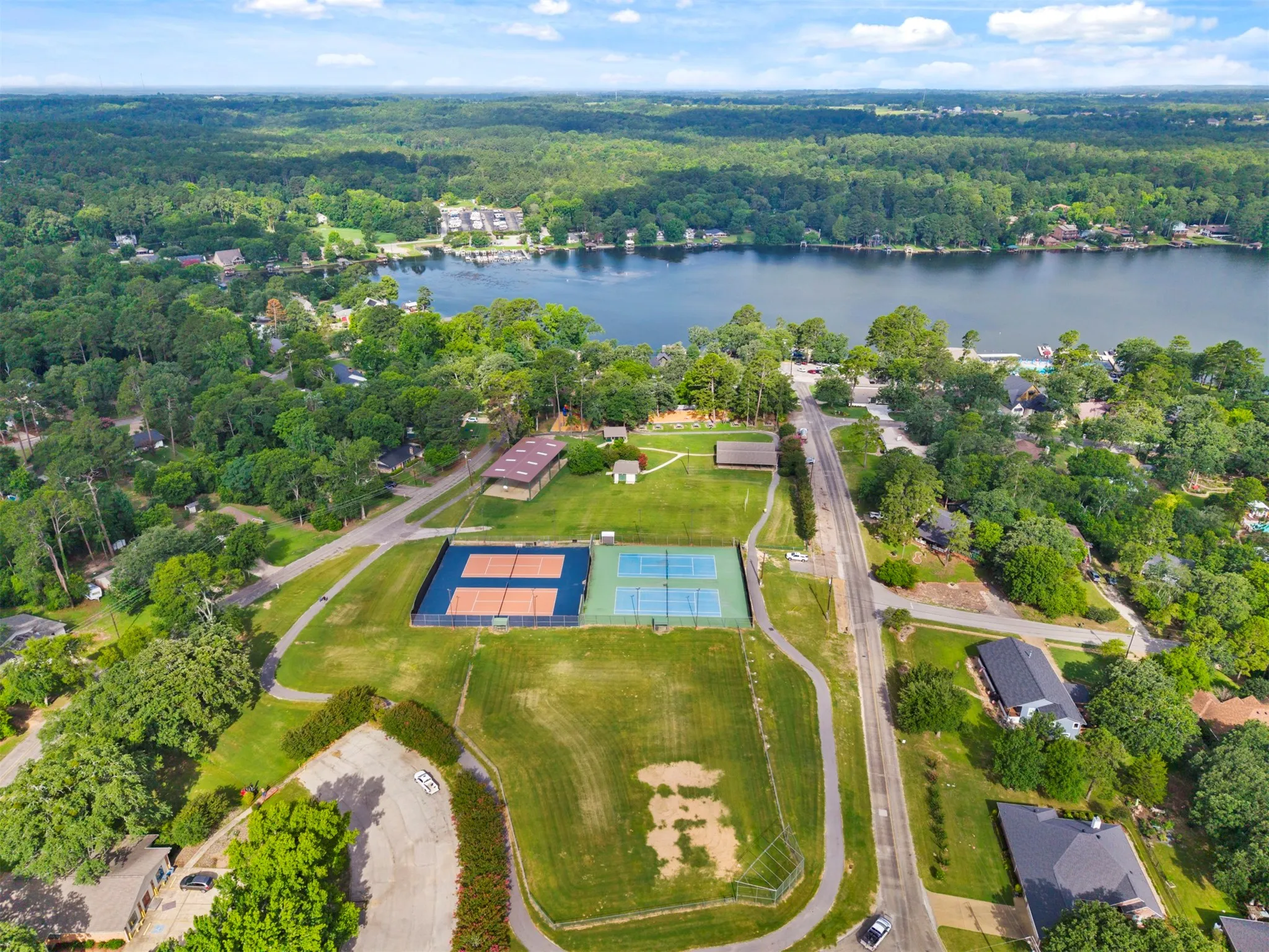 Expansive waterfront property featuring mature trees and established roads