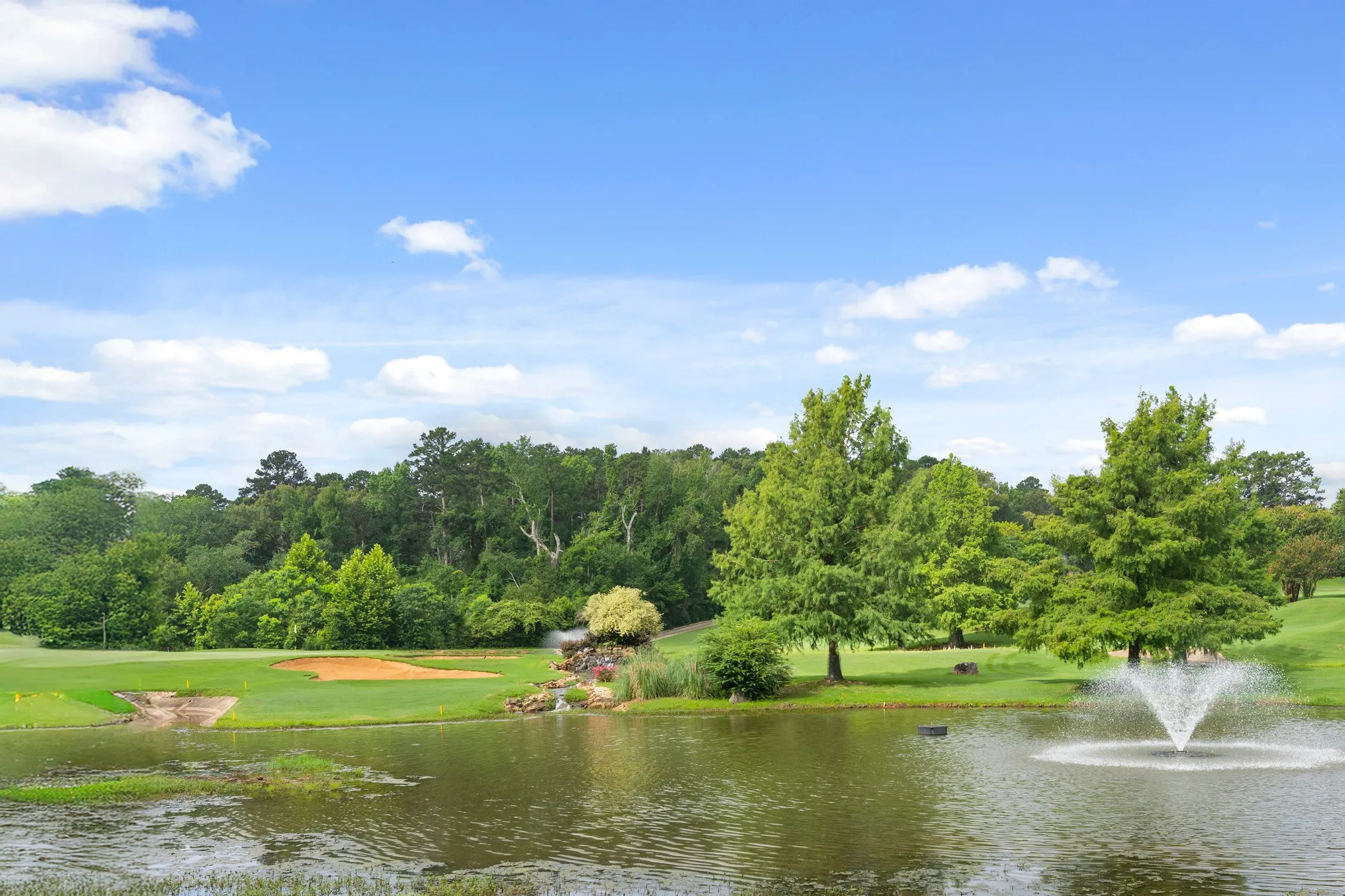Water feature with fountain and surrounding trees