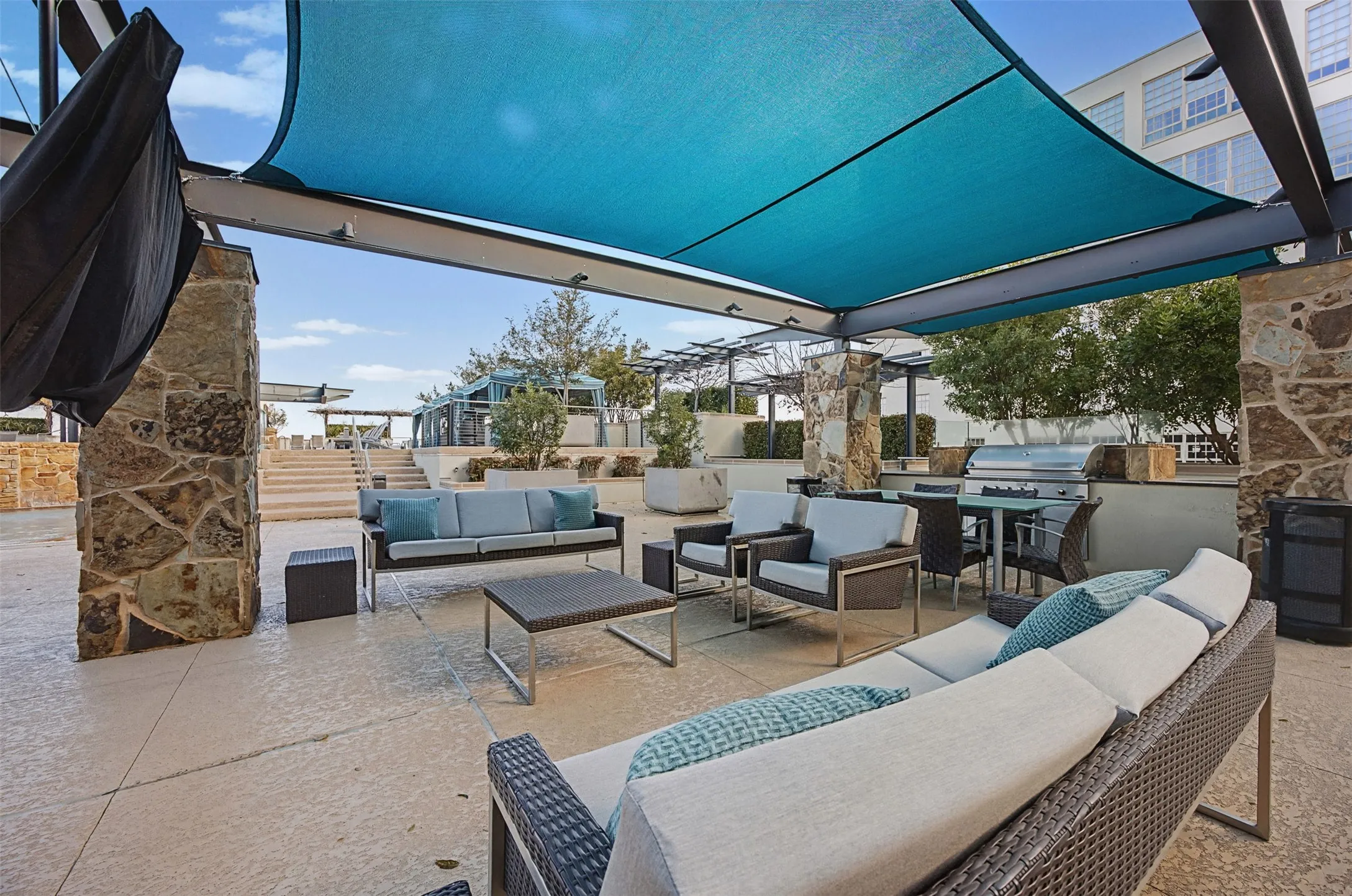 View of patio with an outdoor kitchen with living area