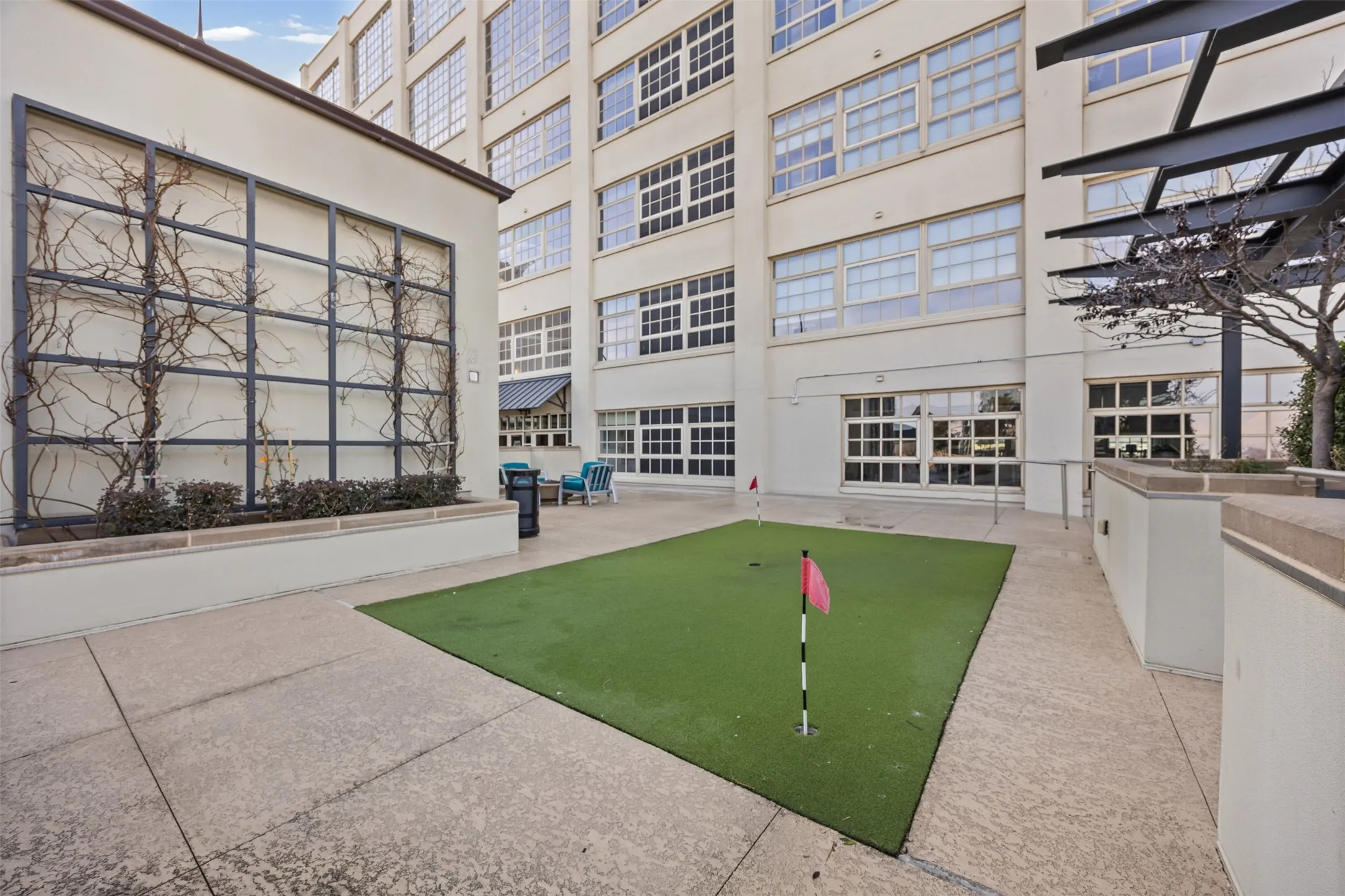 View of home's community with a putting area