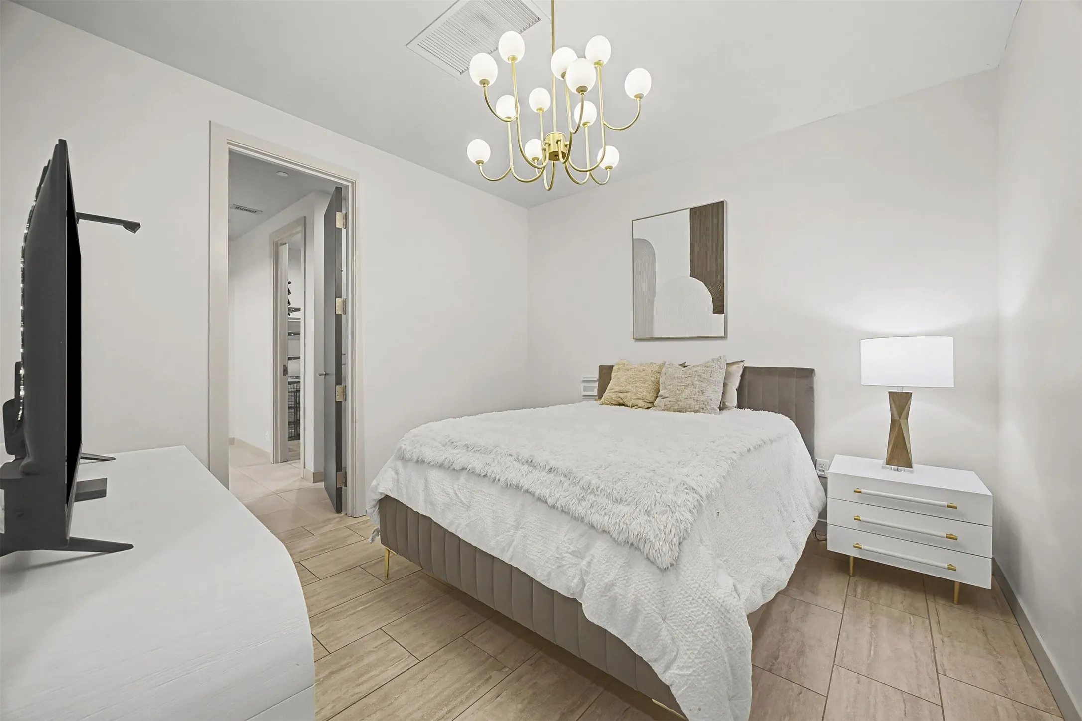 Bedroom with wood finish floors and suspended lighting