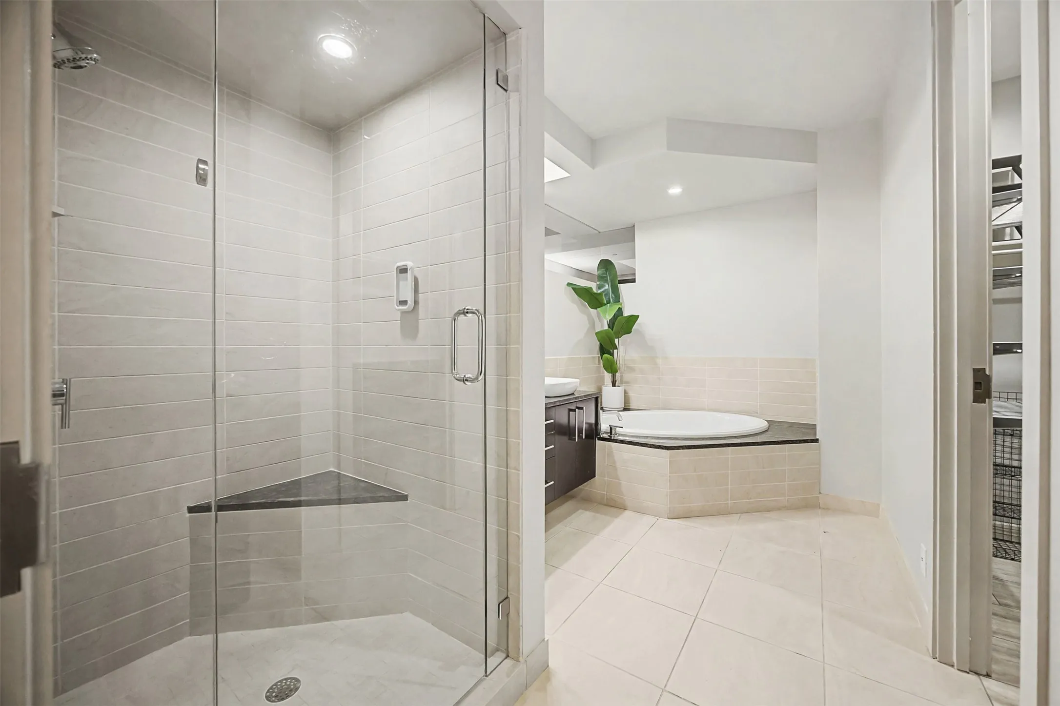 Full bath with vanity, light tile patterned floors, a shower stall, a spacious closet, and a garden​​‌​​​​‌​​‌‌​‌‌​​​‌‌​‌​‌​‌​​​‌​​ tub